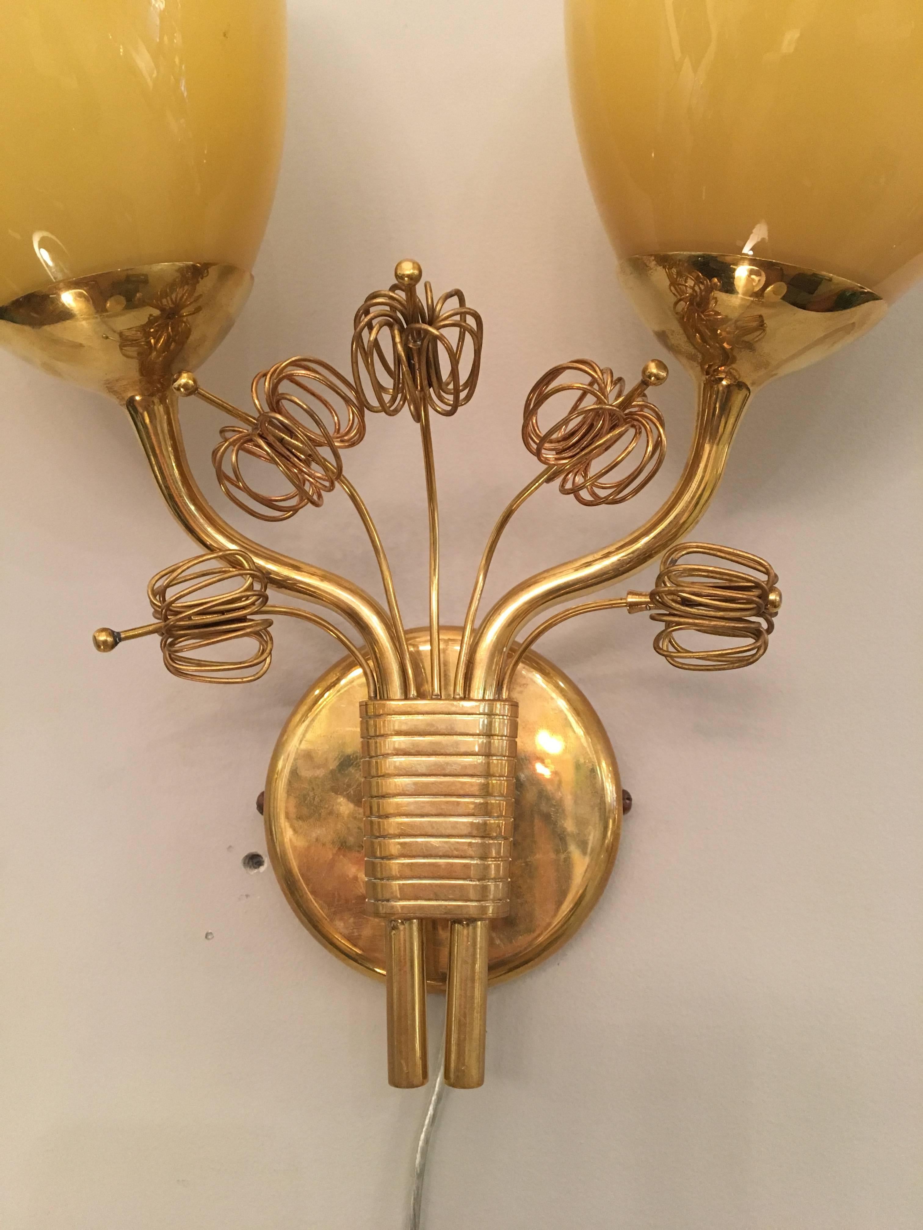 Rare pair of brass and opaline glass sconces by Paavo Tynell for Taito Oy, 1940s.
Sconces have been newly rewired and could be polished upon request.
