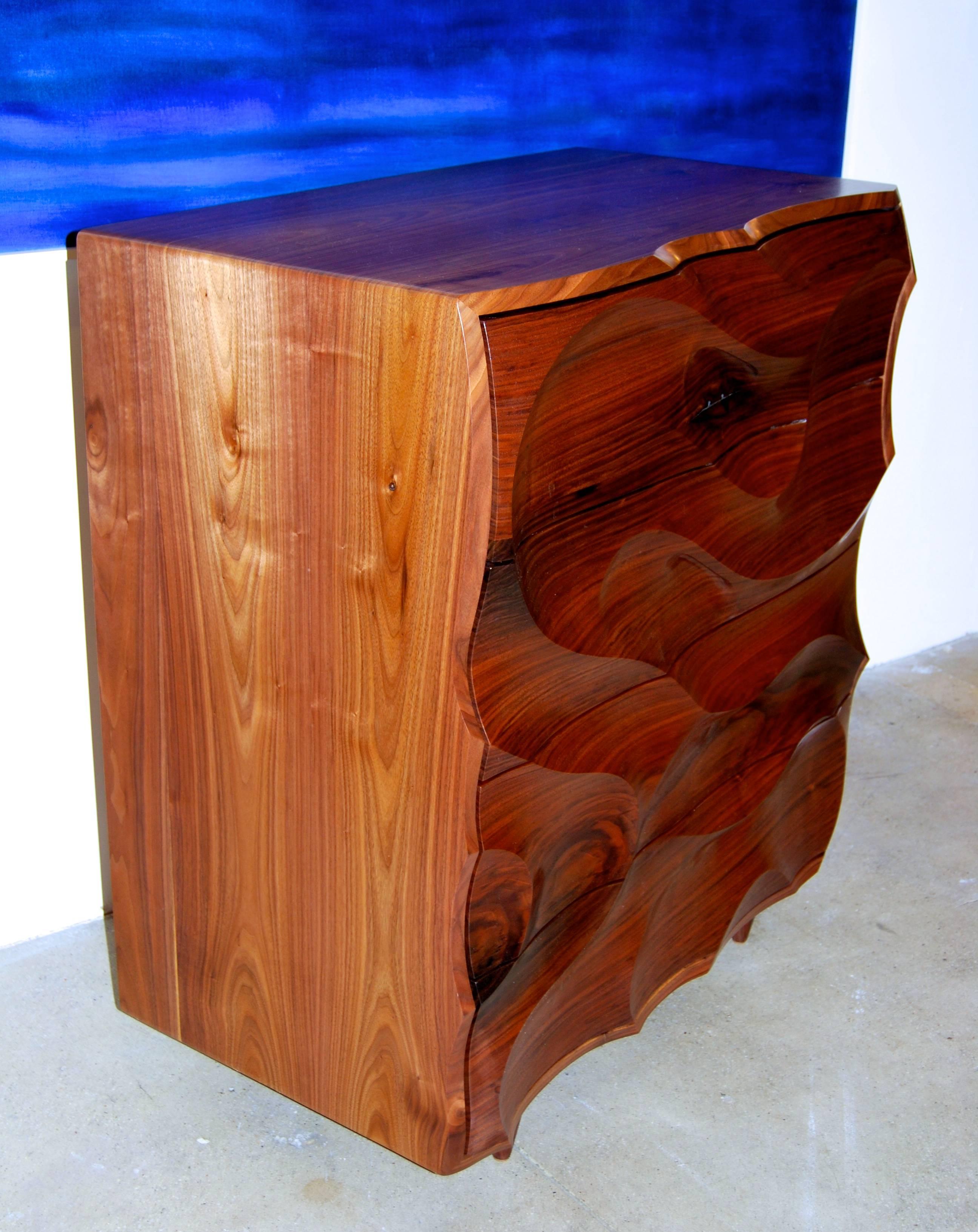 Gentleman's chest or cabinet, hand-carved in solid American black walnut with hand-cut dovetailed drawers in a bookmatched and grain-wrapped case.
Sculpture like quality.
Please inquire if you need to see additional photos.