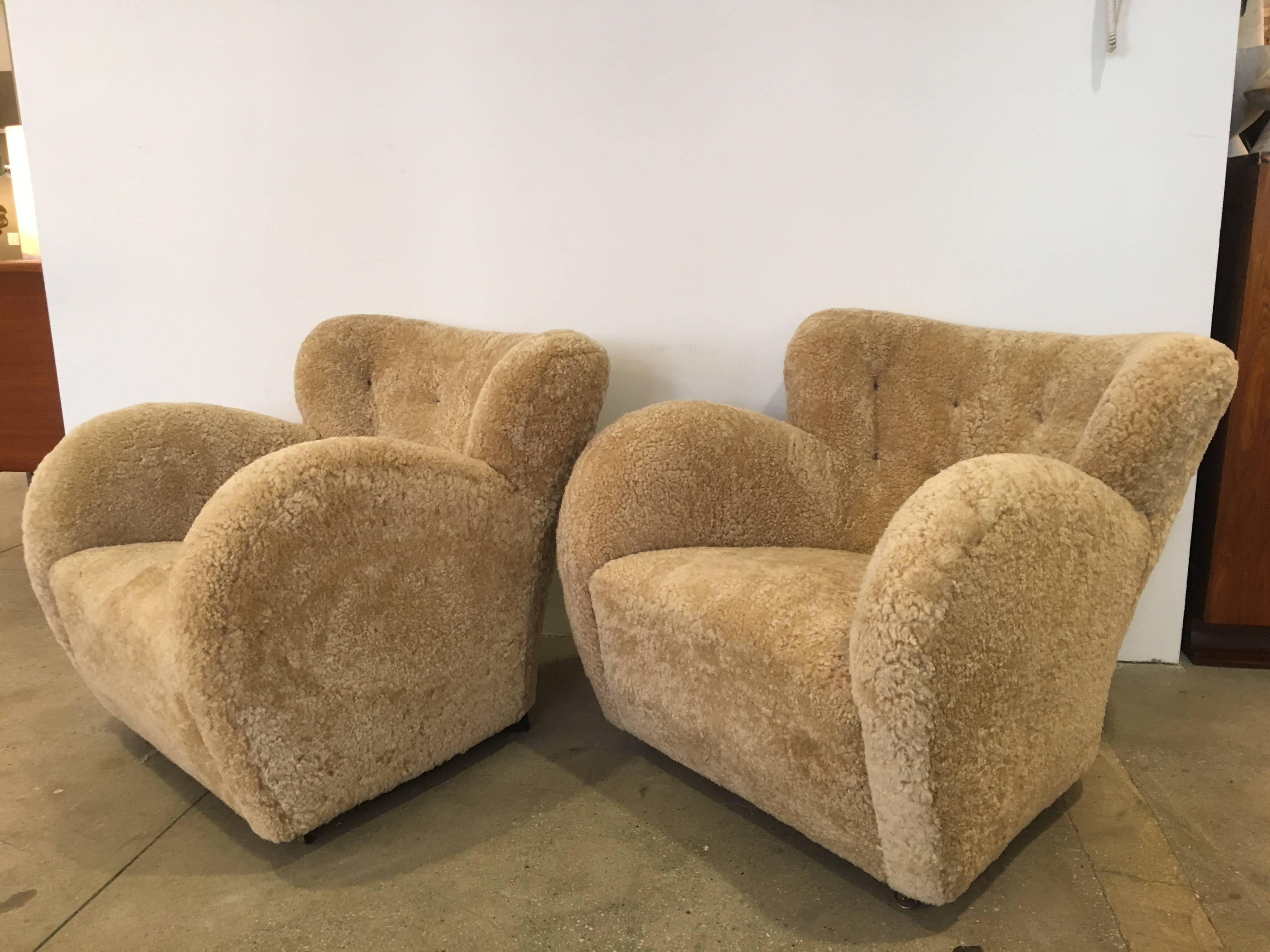 Pair of shapely Flemming Lassen lounge chairs, from the 1940s, recently upholstered in shearling sheep hides.
Original castors present.
Extreme comfort and style.