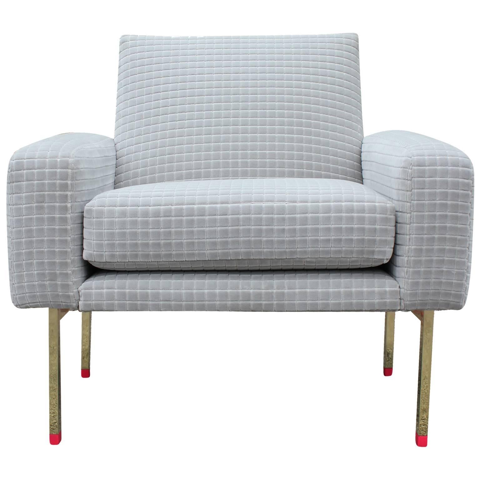 Striking pair of Italian lounge chairs. Chairs are freshly upholstered in a soft grey grid textured velvet. Polished brass legs with hot pink caps make a bold statement. Wonderful pop of color to any space.
