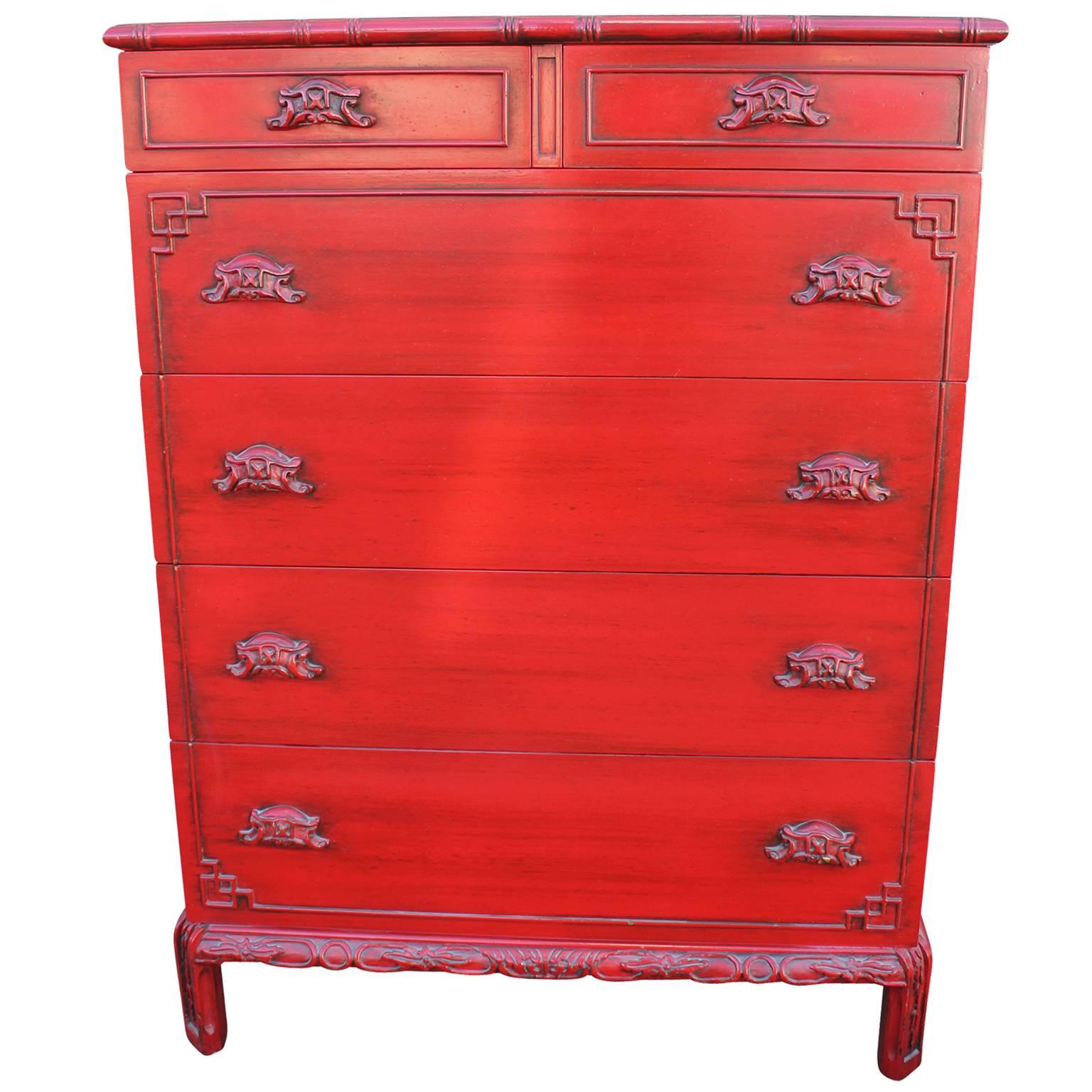 Stunning Chinese inspired dresser. Dresser is finished in an orange-red lacquer with a faux finish. Two small drawers and four large drawers provide excellent storage. The first large drawer is slotted for easy organization. Lovely piece sure to add