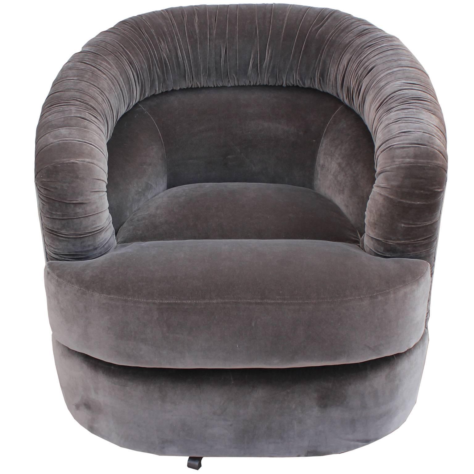 Stunning pair of ultra luxe and comfortable swivel chairs. Chairs are freshly upholstered in a warm grey velvet. A ruched or pleated back adds visual interest to the clean lined piece.