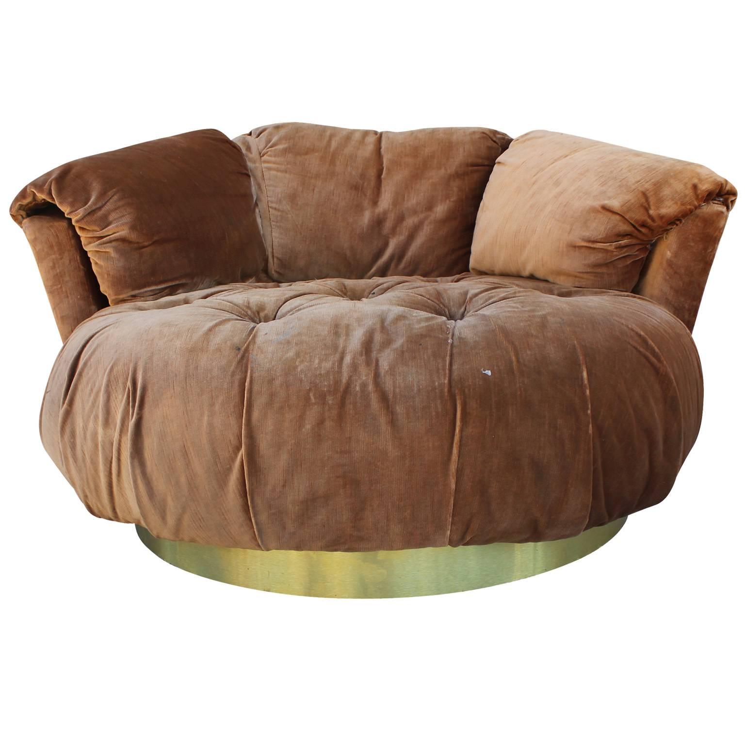 Ultra plush circle Milo Baughman style lounge chair. Attached cushions. Seat is deeply tufted. Chair is upholstered in original brown velvet which needs to be replaced. Chair rests on a brushed brass base. Base shows little signs of wear.