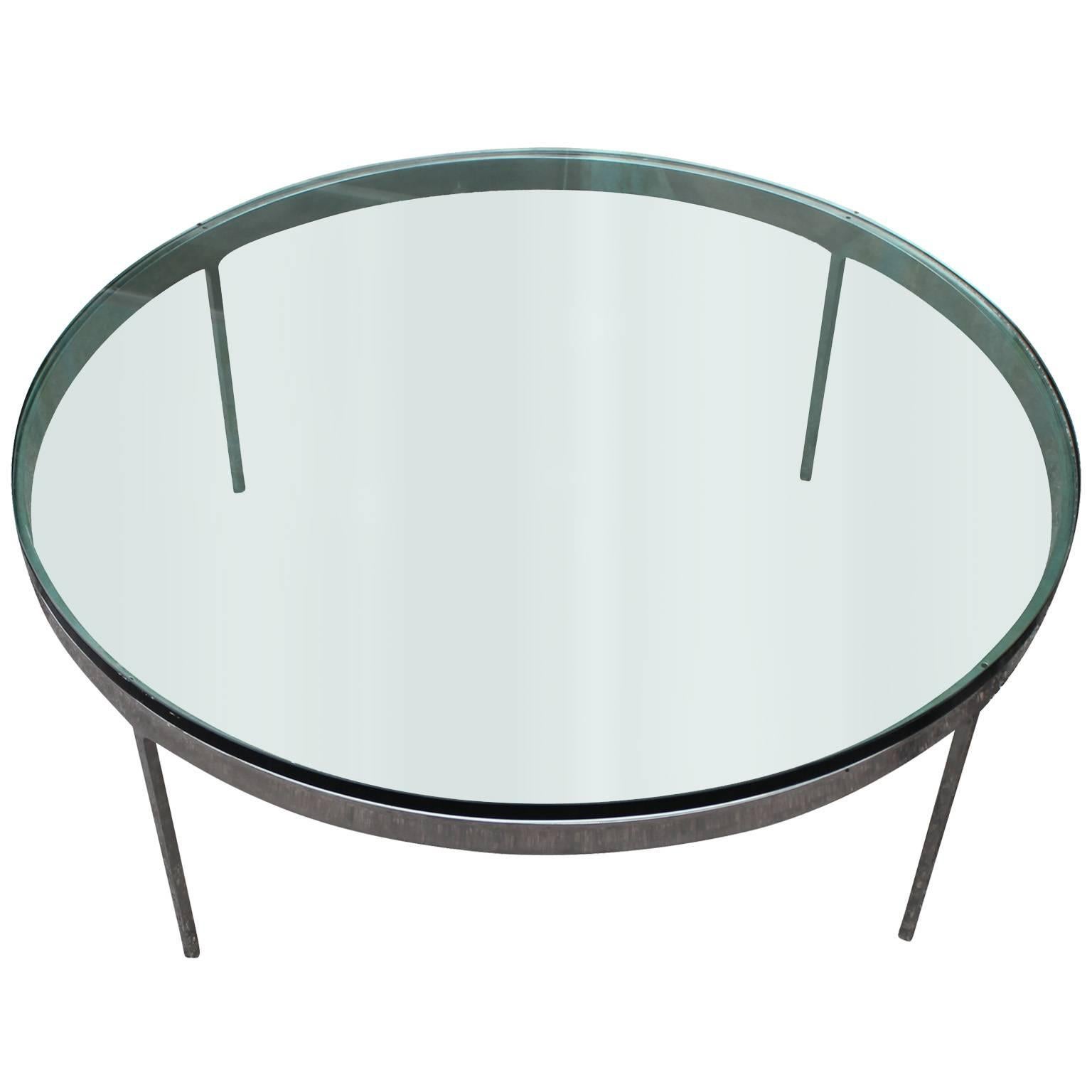 Iconic round coffee table by Nicos Zographos. Elegant stainless steel base is topped with thick cut-glass.