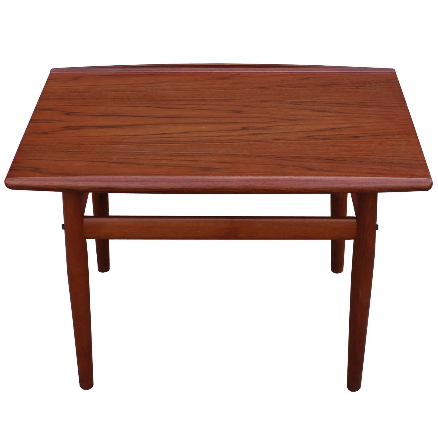 Beautiful teak end or side table designed by Danish designer Grete Jalk for Glostrup. Teak top has a stunning grain. Table has two small, unnoticeable burn marks but is otherwise in excellent condition.