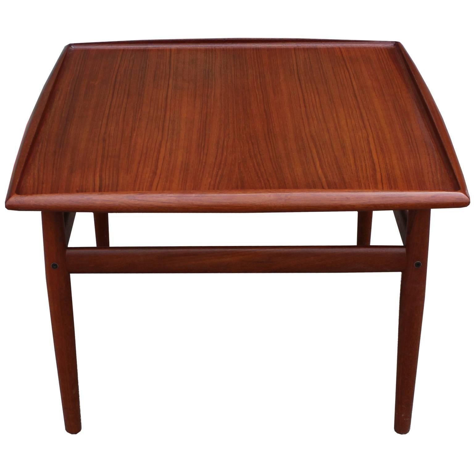 Spectacular teak end or side table designed by Danish designer Grete Jalk for Glostrup. Square table is in excellent condition with beautiful graining.