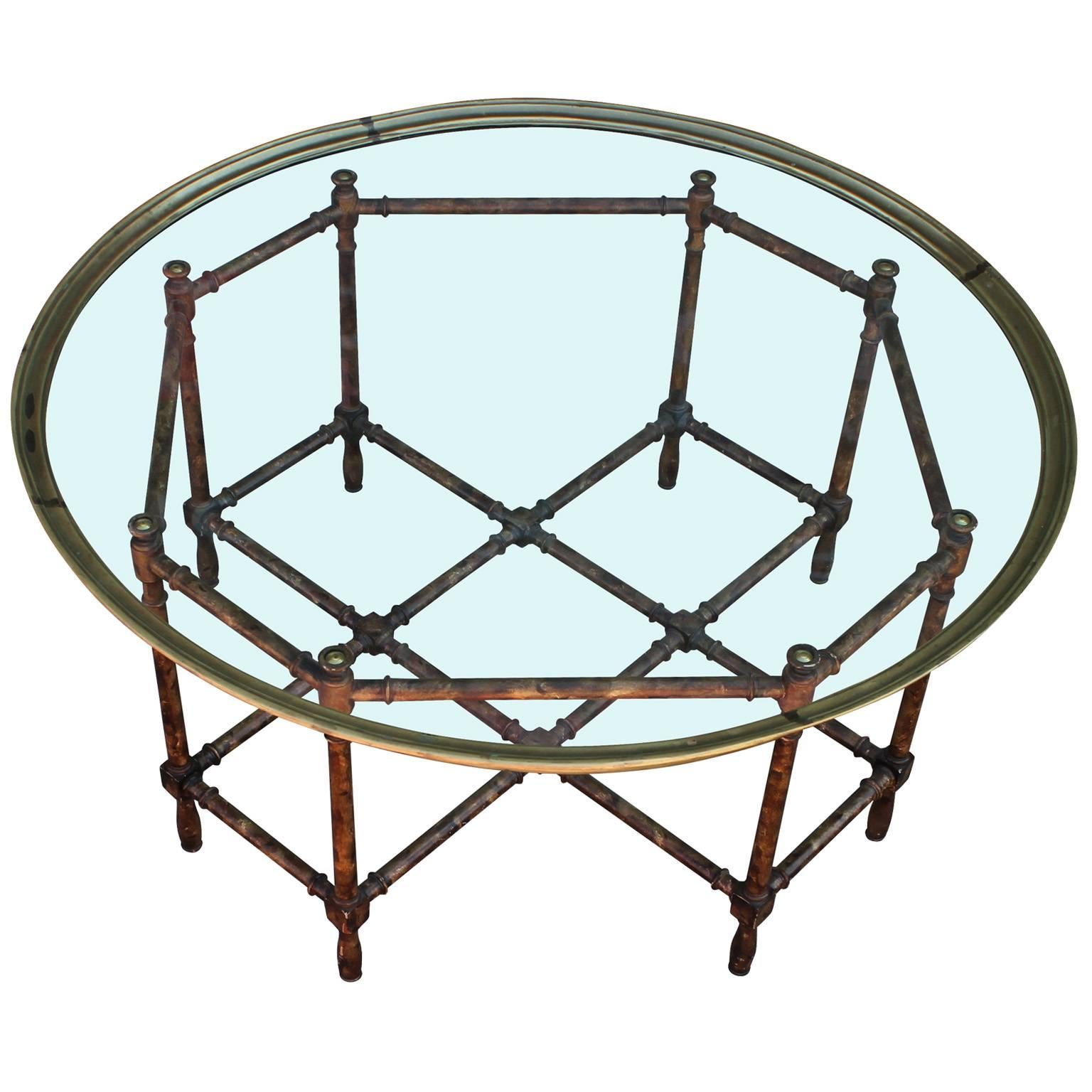 Excellent coffee table by Baker. Faux bamboo base has brass accents. Topped with a sleek, round brass and glass tray. In nice vintage condition.