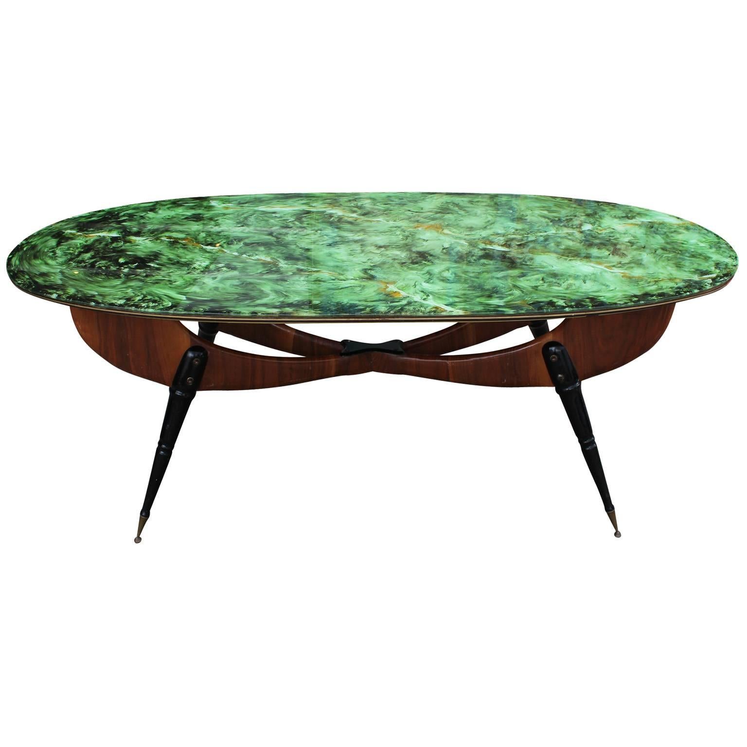 Stunning Italian oval shaped dining table. Reverse painted tabletop is in a kelly green faux marble. Sculptural base is an interesting take on the Classic X-stretcher. Dimensional stretcher is finished with four turned wood legs in black lacquer.