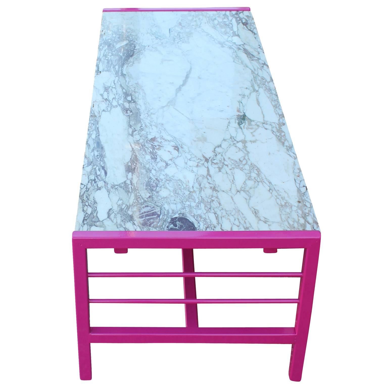 Excellent clean lined Carrara marble topped rectangular coffee table. Table frame is powder coated in a bold pink. Adds a nice pop of color to any space.
