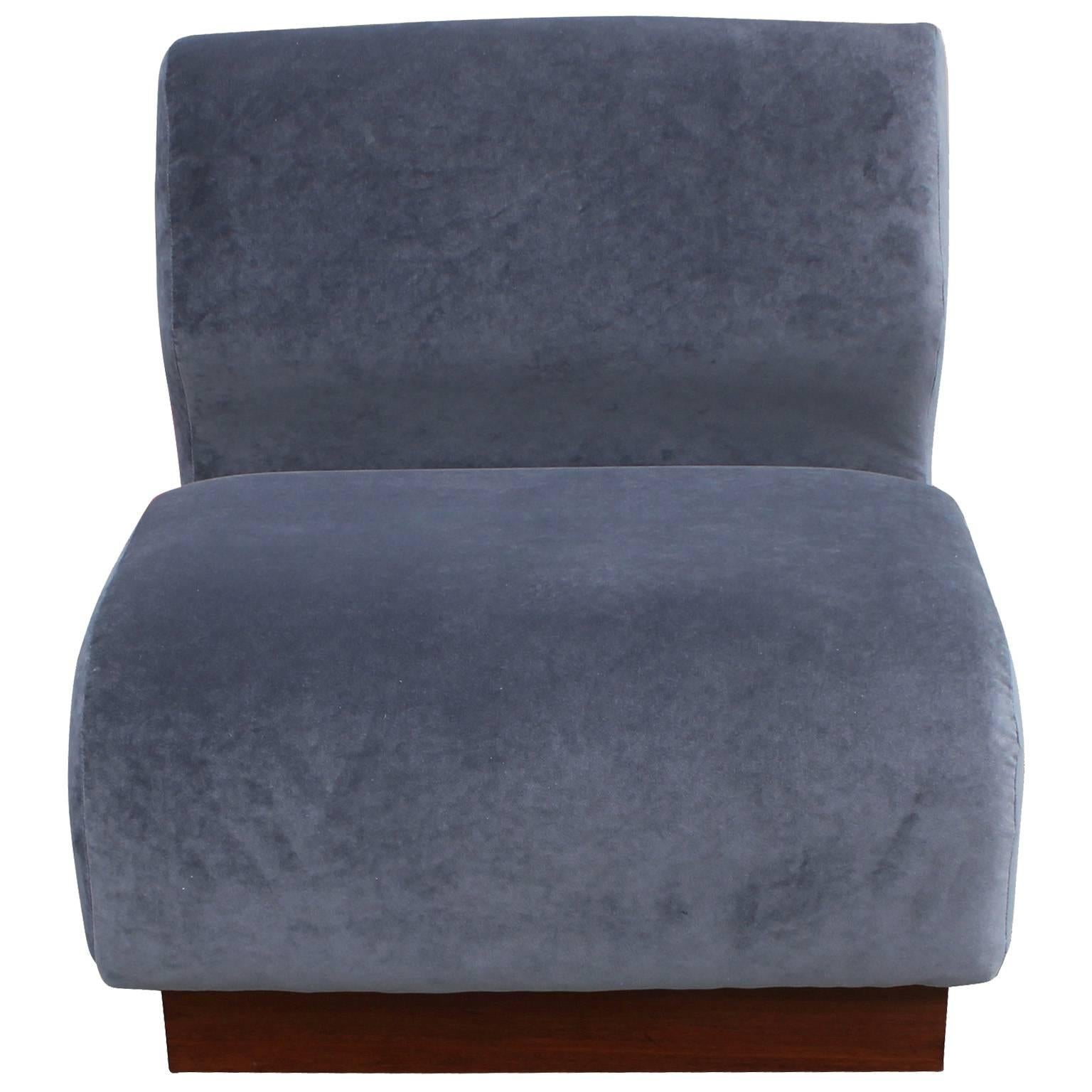 Excellent pair of convertible slipper chairs. Chairs can be pushed together to for a love seat or used separately as slipper chairs. Chairs have fantastic organically curved profiles. Freshly upholstered in a supple grey velvet with a medium walnut
