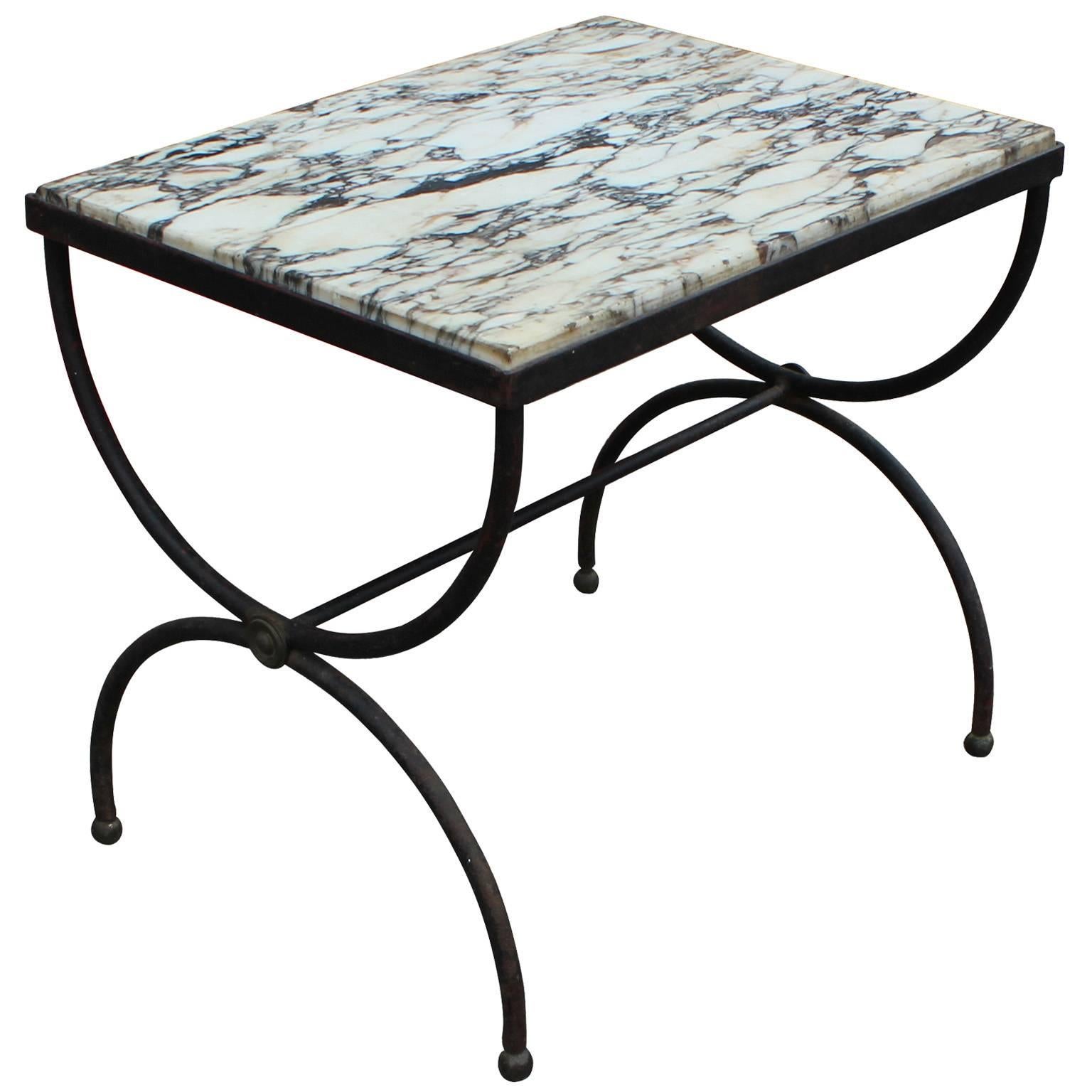 Fabulous pair of French side or end tables. Curved wrought iron "X" bases have the perfect patina. Topped in black and white marble.