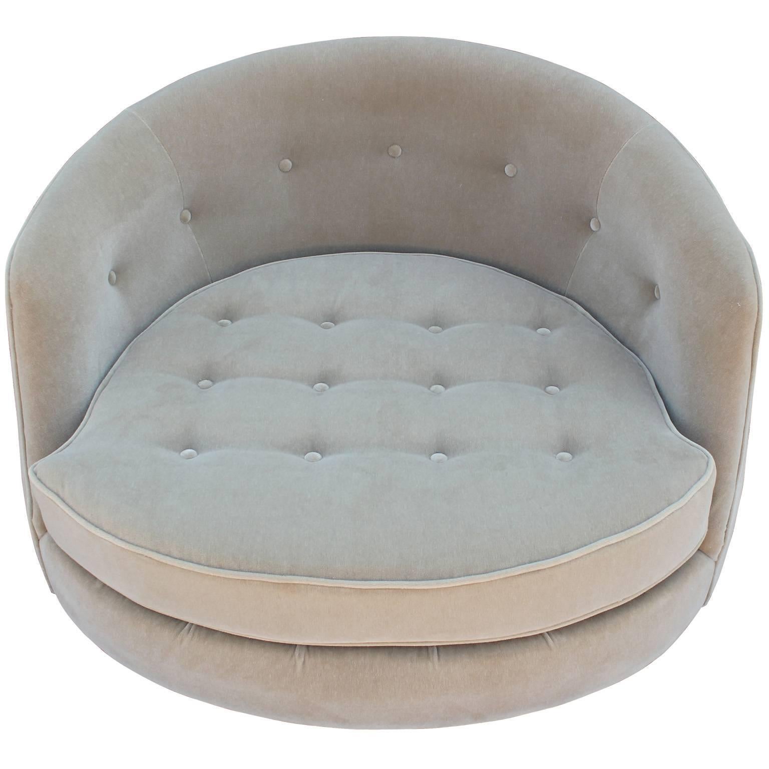 Stunning round barrel back swivel lounge chair by Milo Baughman. Chair is freshly upholstered in a neutral mohair velvet. Tufting and piping add visual interest. Chair rests on a walnut drum swivel base. Excellent restored condition.
