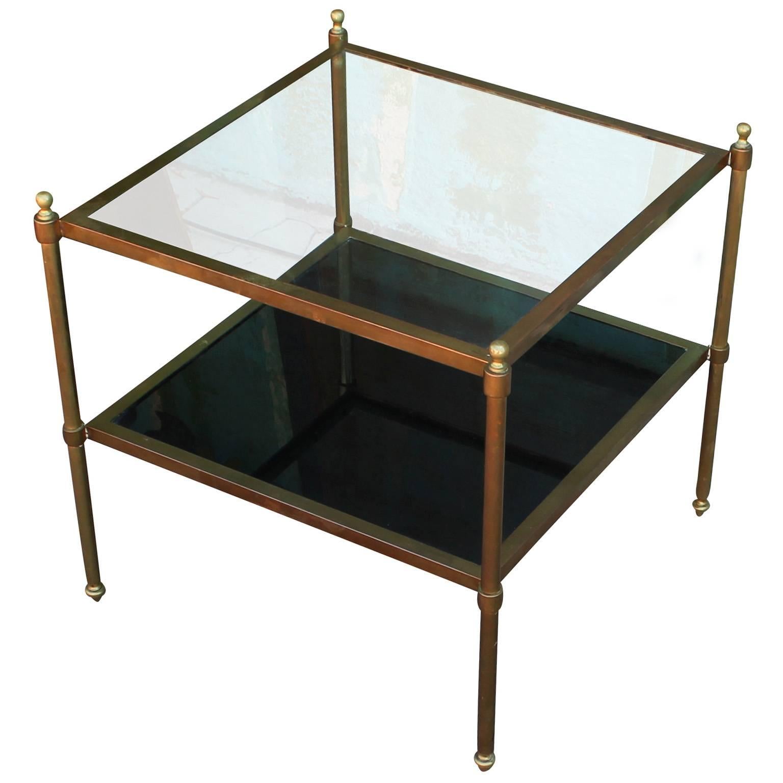 Fab pair of brass and glass end or side tables. Delicate brass frames have excellent proportions. Bottom shelf is an opaque black glass.