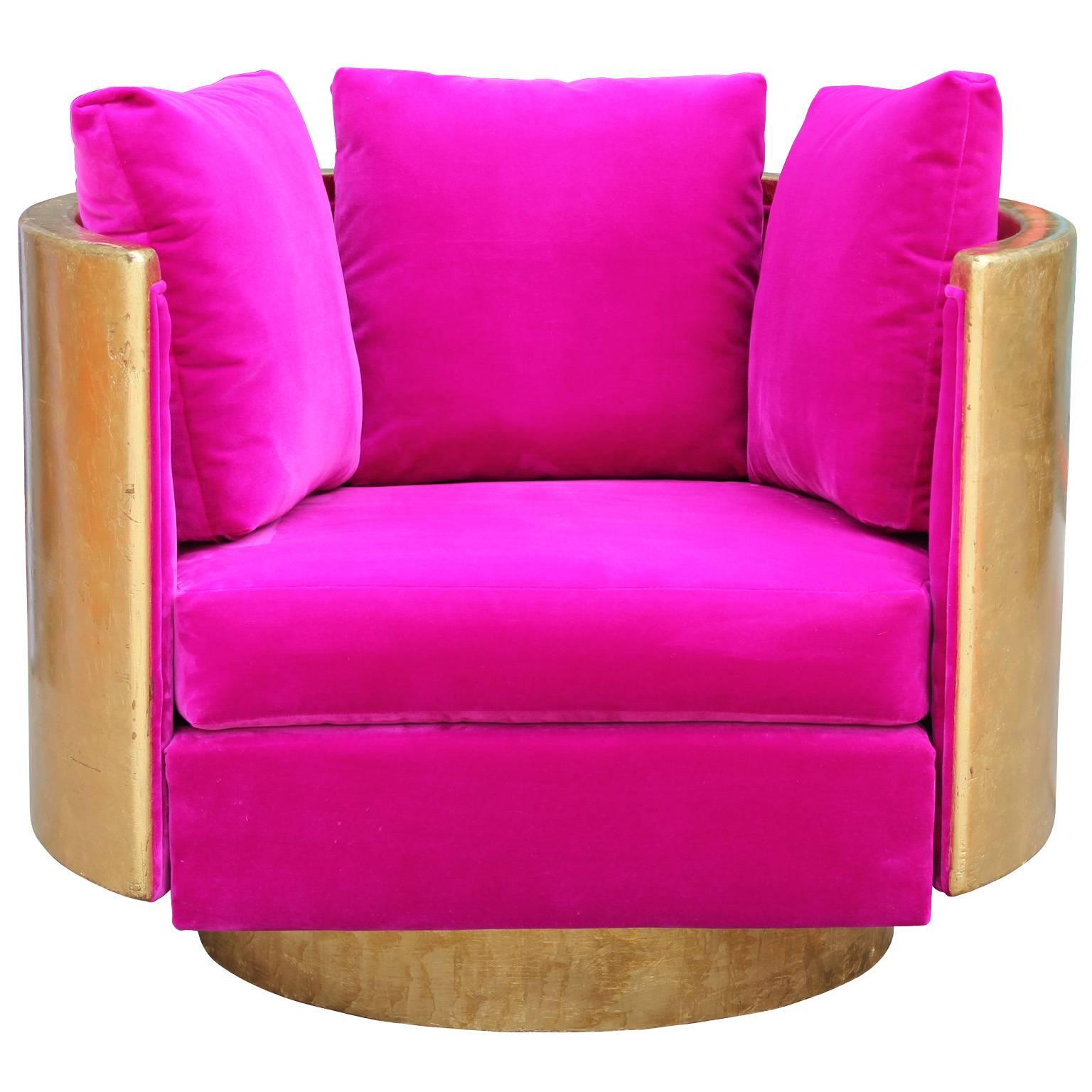 Luxe round barrel back swivel chair freshly upholstered in plush fuchsia pink velvet. Wood case frame is gold leafed. Lounge chair is sure to make a statement in any space. Superb quality.