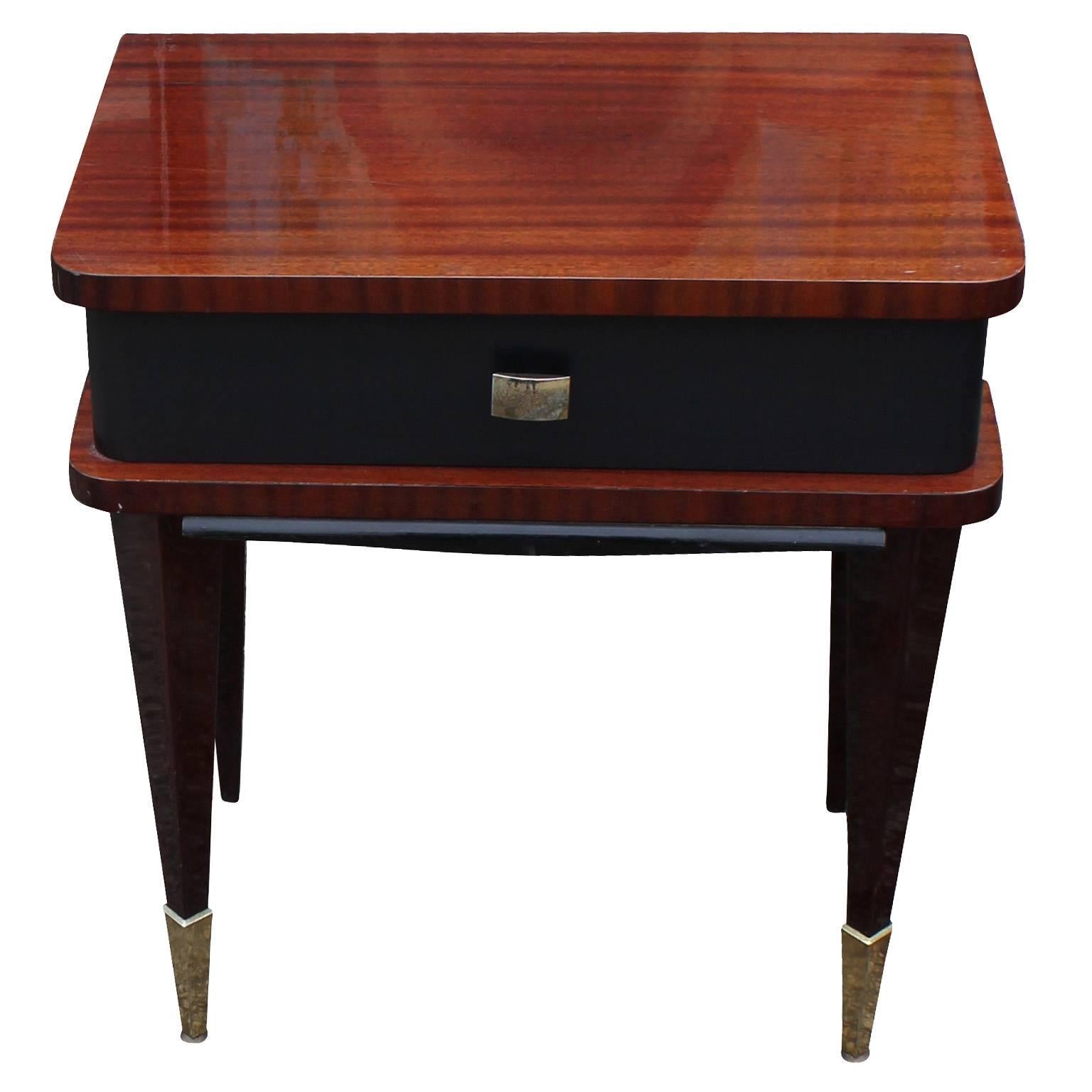 Excellent pair of French nightstands or side tables. Nightstands have excellent graining with a super glossy French polish. Drawer fronts nicely contrast the piece finished in a matte black. Tapered legs are finished in brass caps.