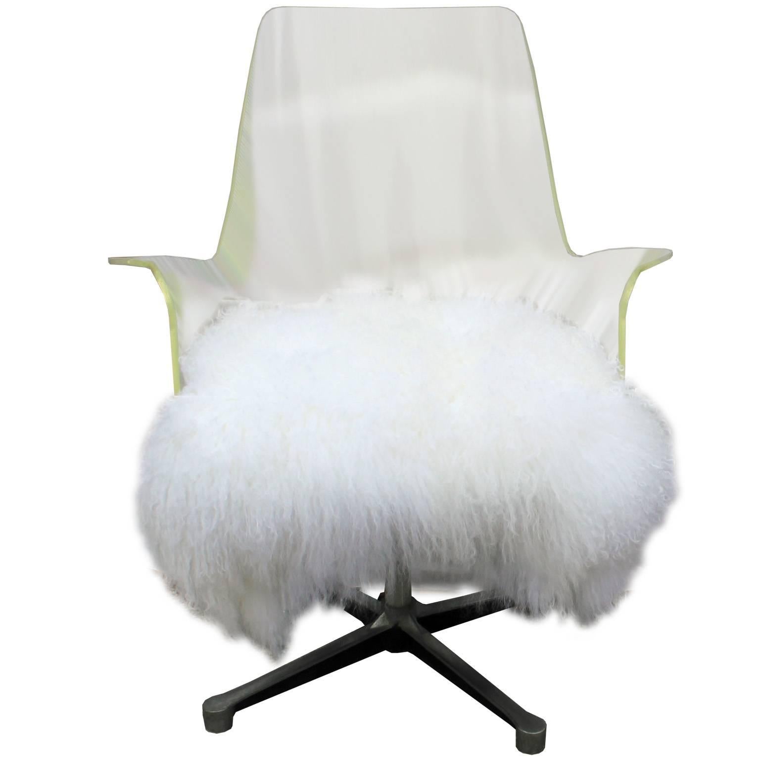 Stunning high backed Lucite swivel lounge chair. Lucite chair has an excellent form with curved arms. Seat is upholstered in fluffy white Mongolian sheepskin. Swivel base is steel with black accents. Perfect in a Hollywood Regency, Mid-Century,