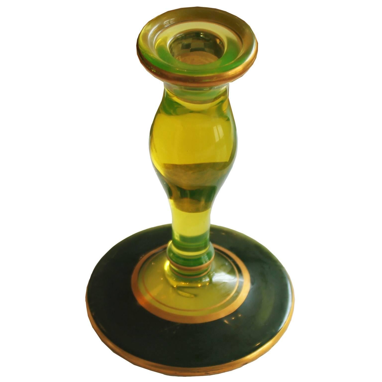 Charming pair of glass candlesticks in the style of Murano. Glass is a bright lime green and is accented with black and gold gilt. Perfect addition to a Hollywood Regency or modern interior.