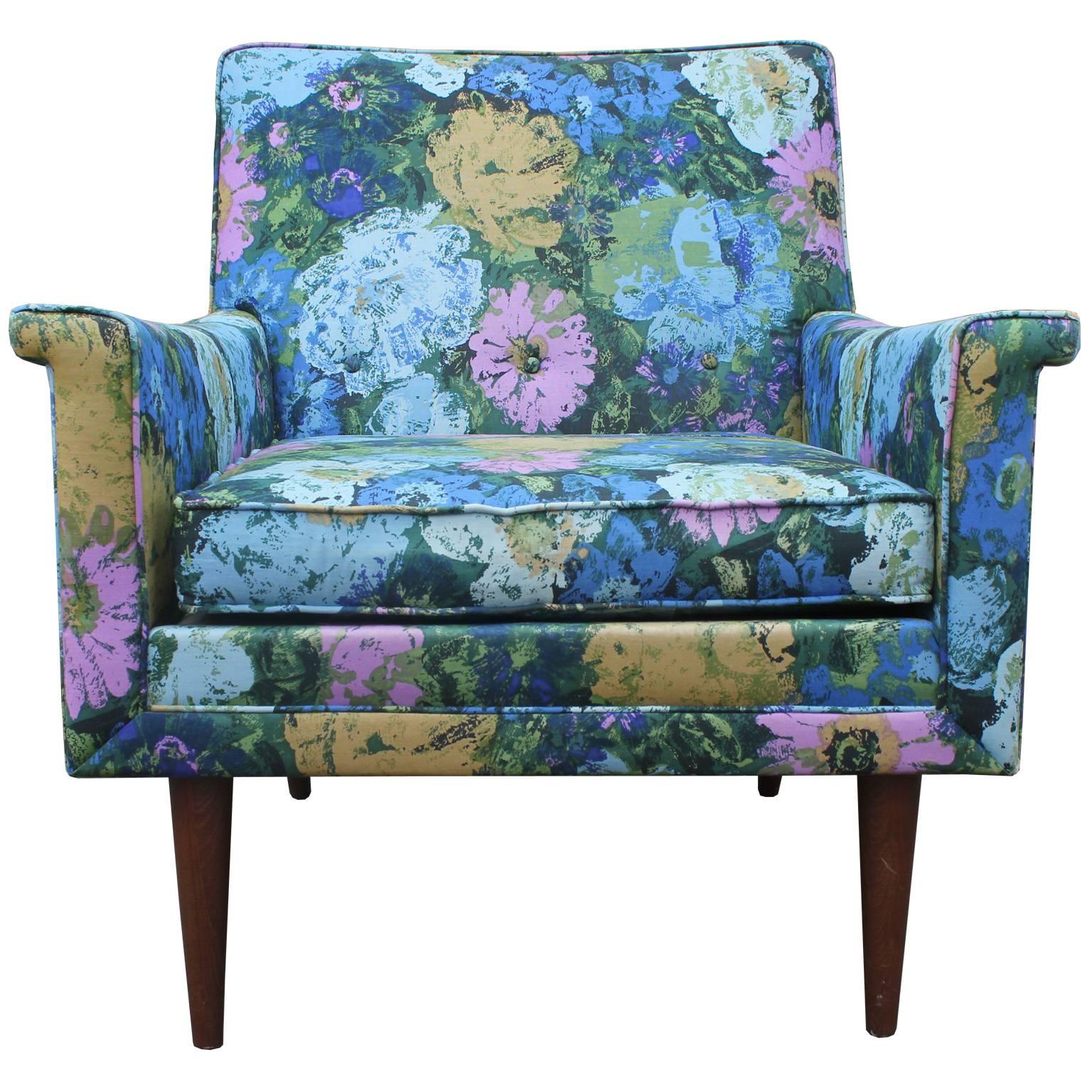 Fabulous lounge chair in original floral fabric. Upholstery is in good vintage condition with very light wear and very usable. Chair has great Mid-Century lines with flared out arm rests. Tapered legs are in a medium walnut. The chair is attributed