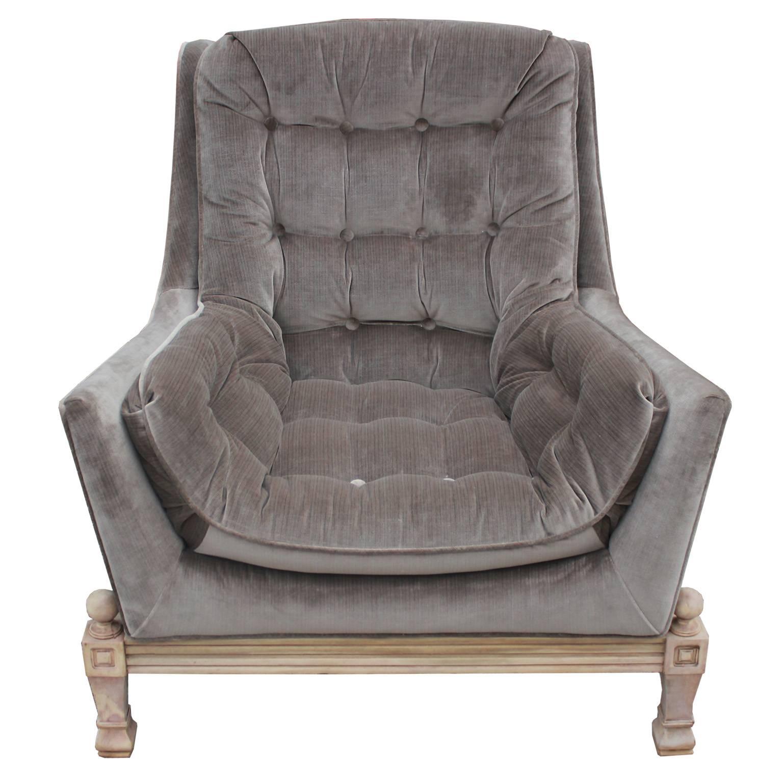 Striking Hollywood Regency style lounge chair and ottoman. Chair are freshly upholstered in a luxe grey velvet with a subtle pinstripe. Bases have a traditional feel which nicely complement the modern lines of the seat. Bases are finished in raw