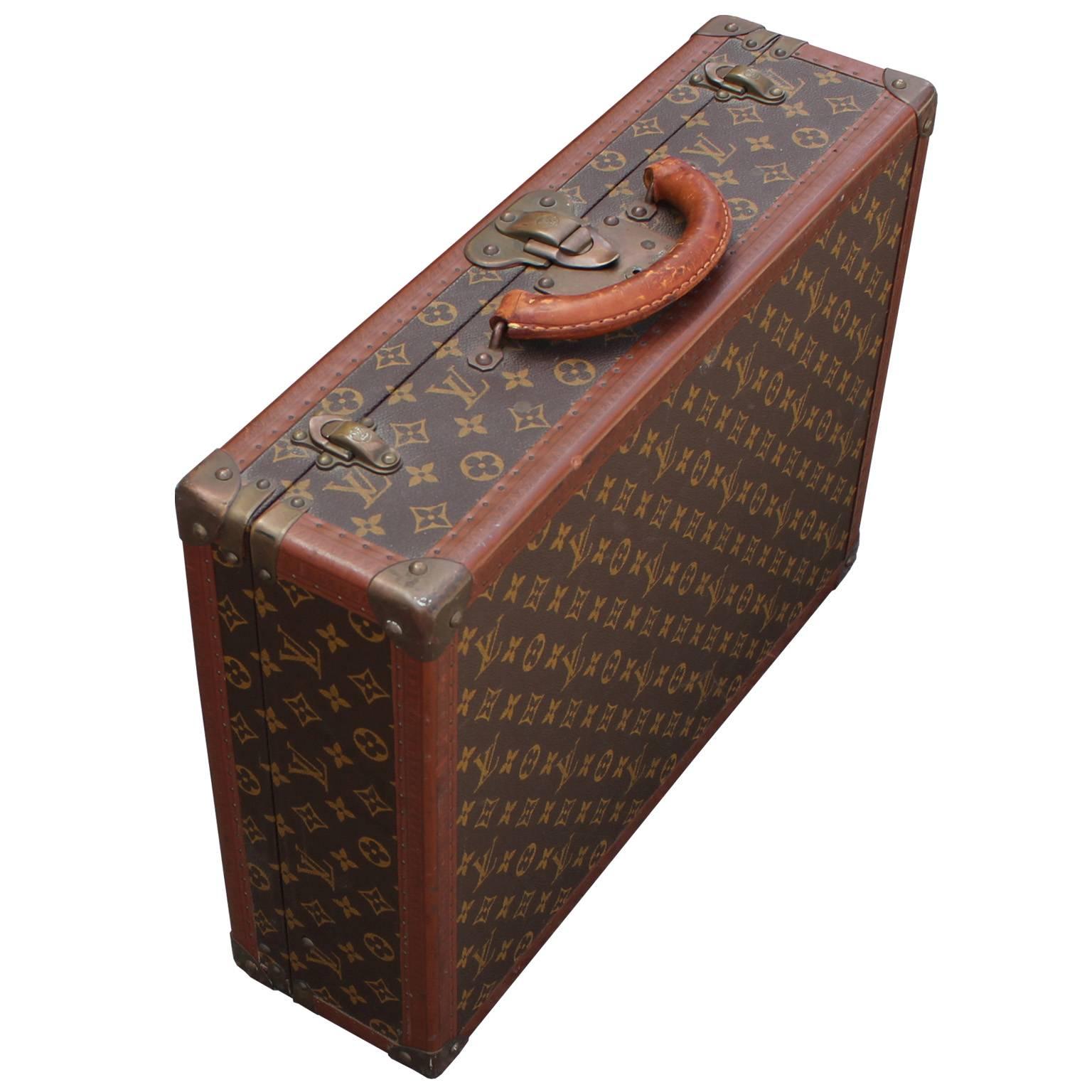 Glamorous Louis Vuitton suitcase in the iconic monogram canvas. Brass fittings and leather trim have an excellent patina. Perfect accent to any space. Inquire for matching, larger sized suitcase.