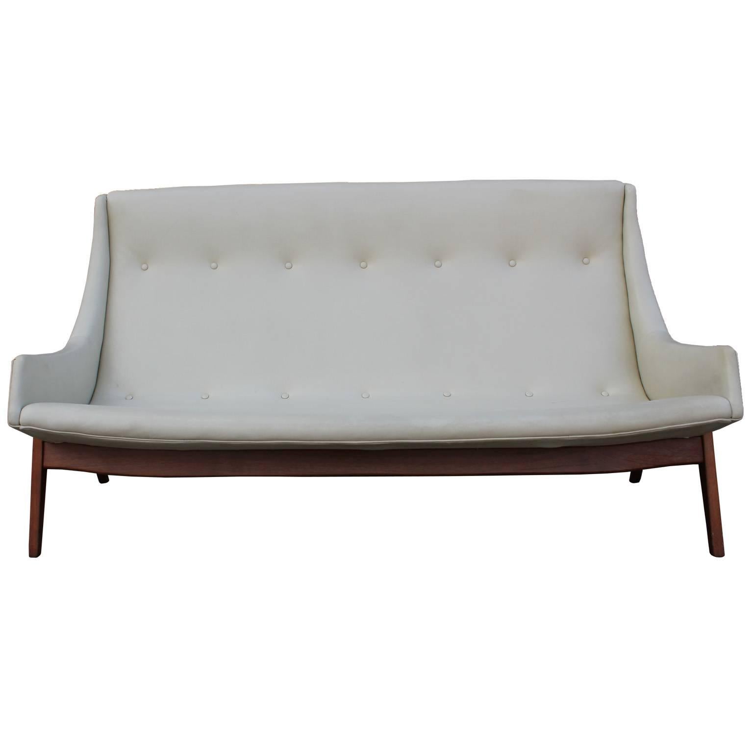 Early Milo Baughman for Thayer Coggin sofa. Sofa has elegant curved lines which nicely contrast the dramatic splayed teak legs. Sofa is in all original condition and needs to be reupholstered. We can do this for you at an additional charge. Stunning