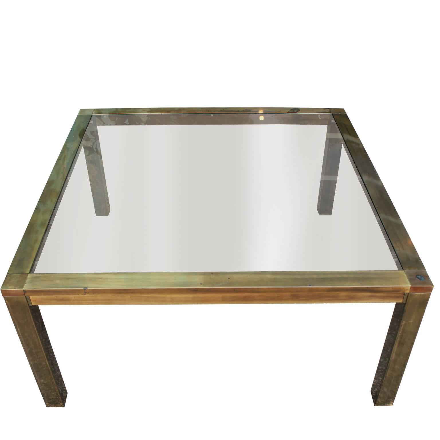 Fabulous Parsons style coffee table attributed to Mastercraft. Brass base has a wonderful patina. Smoked glass top. Perfect in a modern, transitional, Mid-Century or Hollywood Regency space.