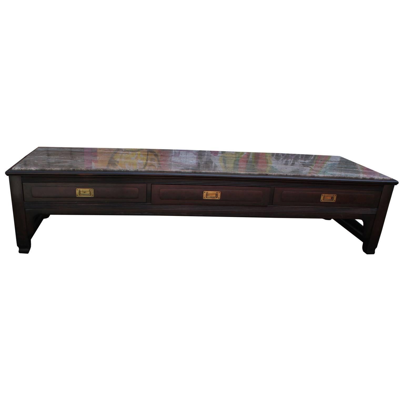 Elegant coffee table by Widdicomb. Dark walnut base has a wonderful attention to detail. Three drawers outfitted with brass Campaign Style hardware provide storage. Marble tabletop has excellent graining.