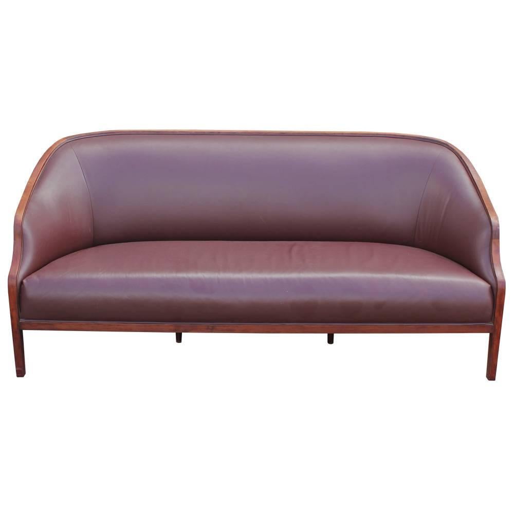 Elegant sofa designing by Ward Bennett. Walnut frame has beautiful, gently curved lines. Sofa is upholstered in rich and chocolate brown leather that is in very nice vintage condition. Stunning piece would work well in a transitional, modern or