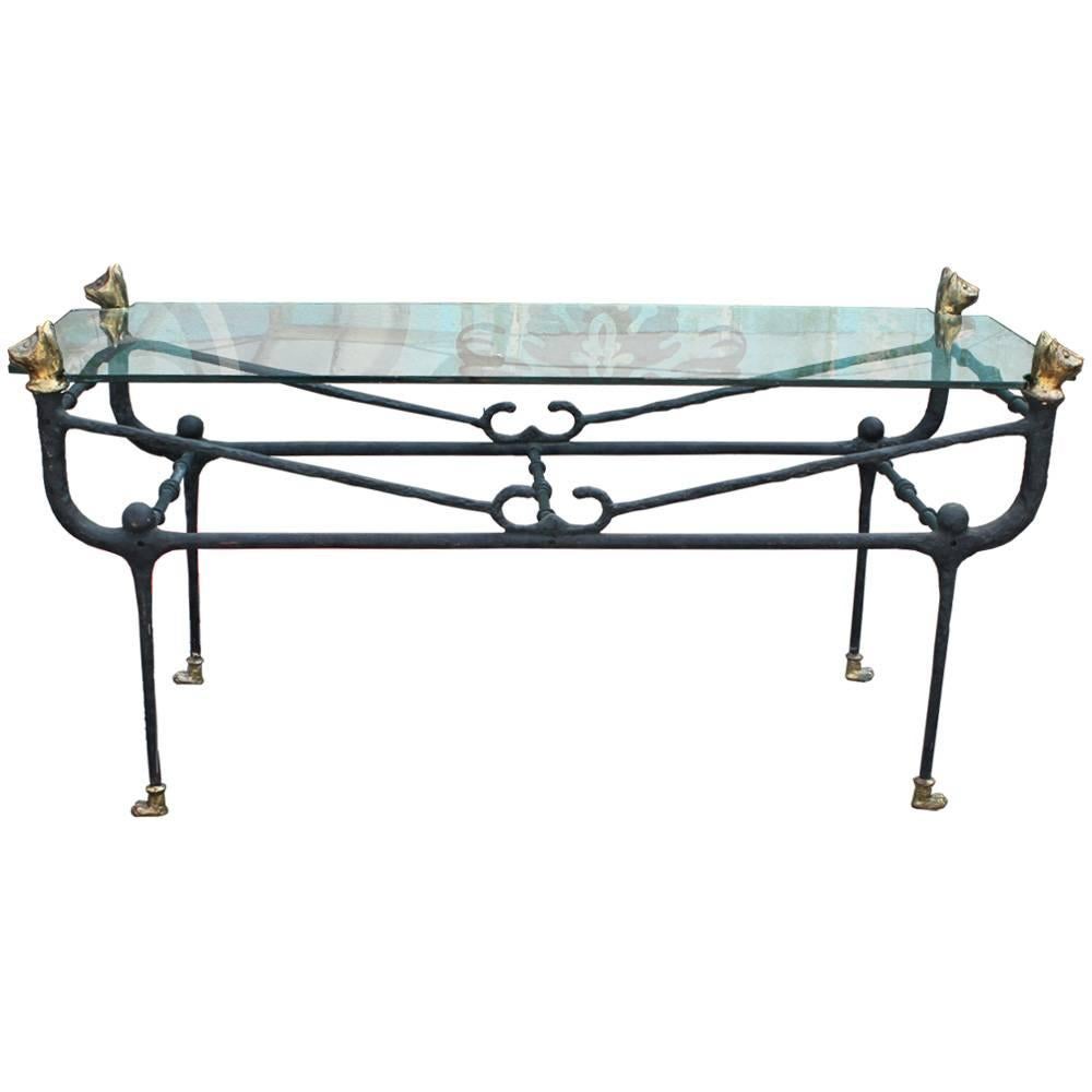 Lovely iron and glass console table in the style of Giacometti. Table features a whimsical brass cat motif. Cat feet and heads are gilded. Console would be the perfect accent to a Brutalist or modern space.