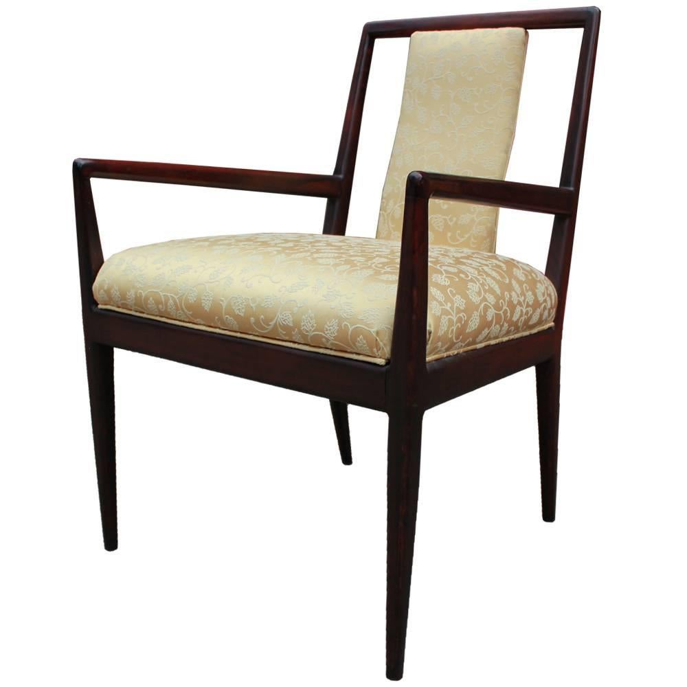 Set of six sophisticated and clean lined ding chairs. Dark reddish walnut frames have clean and delicate lines with lots of negative space. Set includes two armchairs and four side chairs. Chairs are upholstered in a vintage yellow floral which