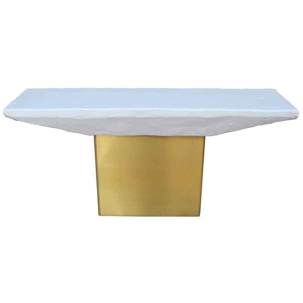 Fabulous pair of console tables. Tables are topped with white lacquered terracotta. Bases are wrapped in a brushed brass. Glamorous console tables would be perfect in a modern or Hollywood regency style space. Attributed to Milo Baughman.