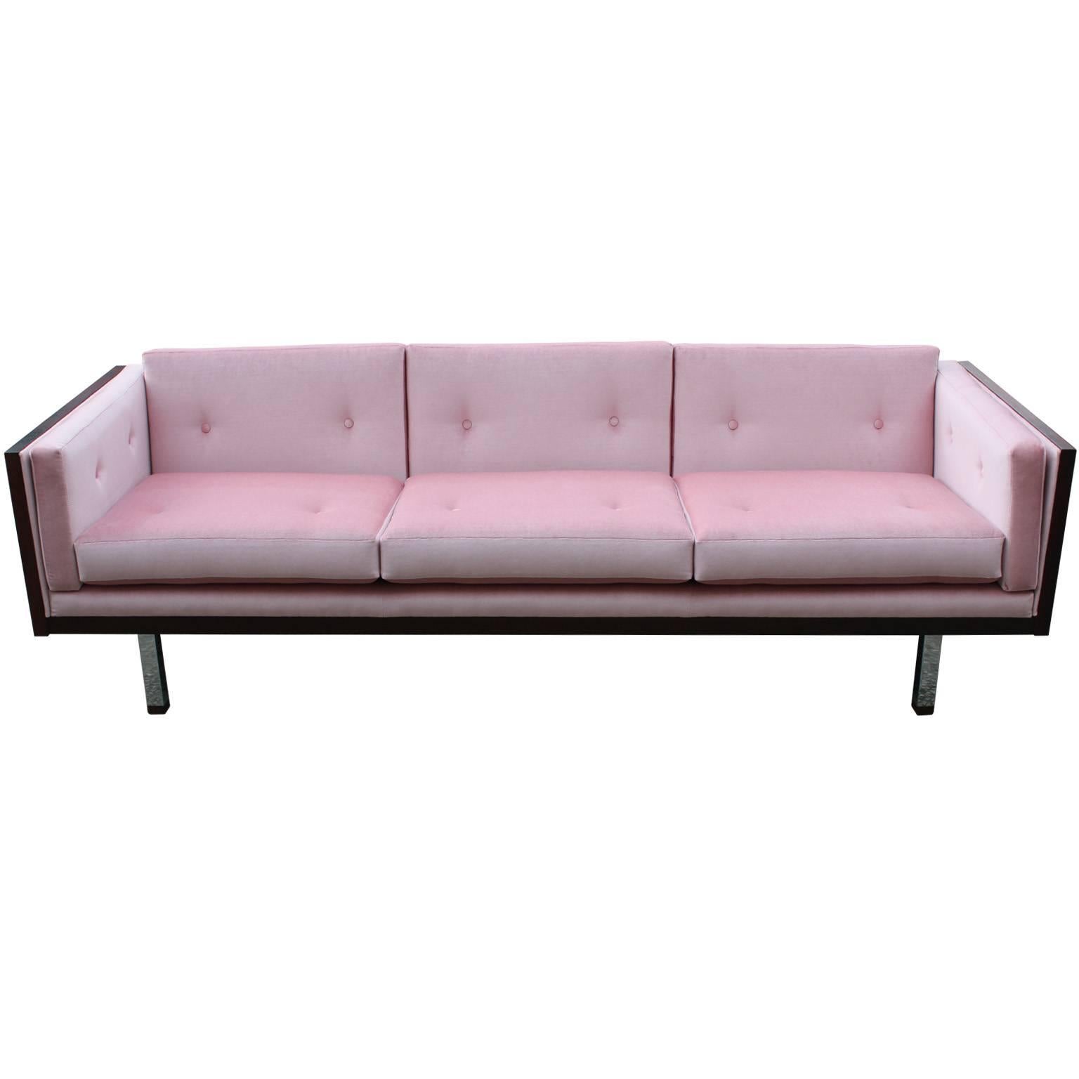 Stunning rosewood case sofa attributed Milo Baughman for Thayer Coggin. Rosewood veneer has beautiful graining. Sofa is freshly upholstered in a buttoned silky pink velvet. Simple chrome legs finish the sofa.