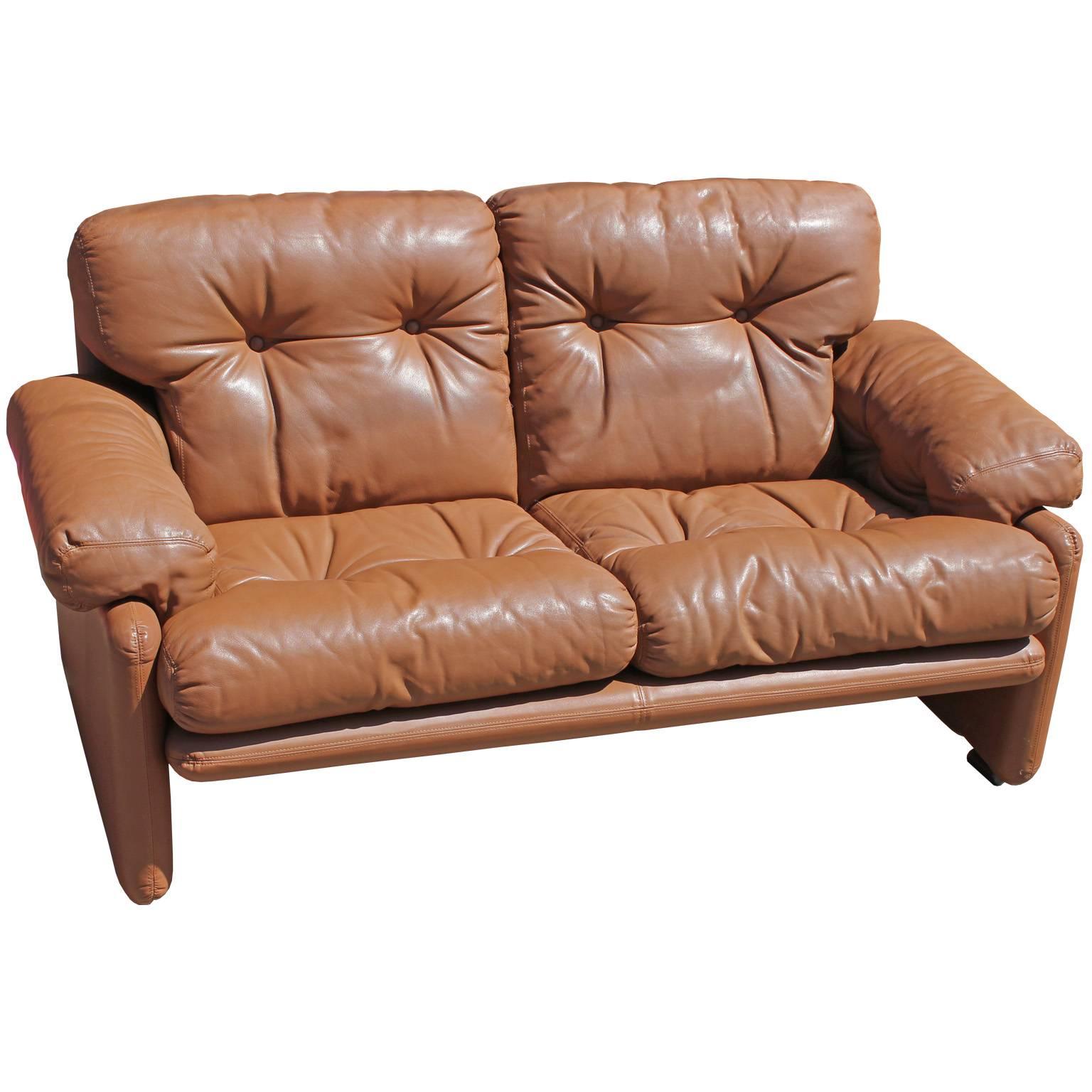 Wonderful pair of leather loveseats by B&B Italia. Caramel colored borwn leather is in great, vintage condition. Sofas would look perfect in a safari style, modern, or Mid-Century space. Matching three seat sofa available. In great vintage