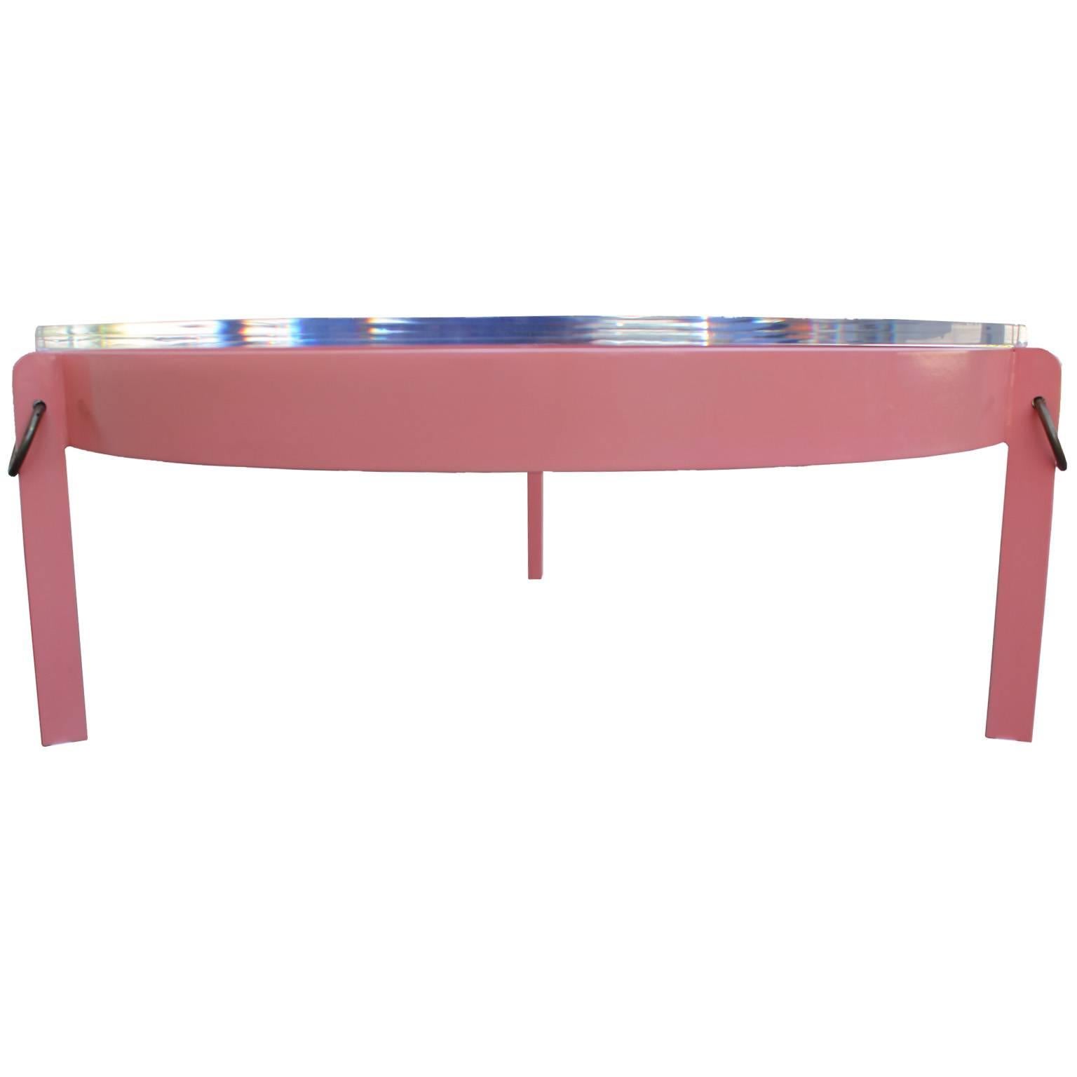 Glamorous round coffee table. Metal base is freshly Lacquered in a coral pink with brass ring accents. Topped with thick Lucite and brass rings. Table will look perfect in a Hollywood Regency, Mid-Century or modern space.