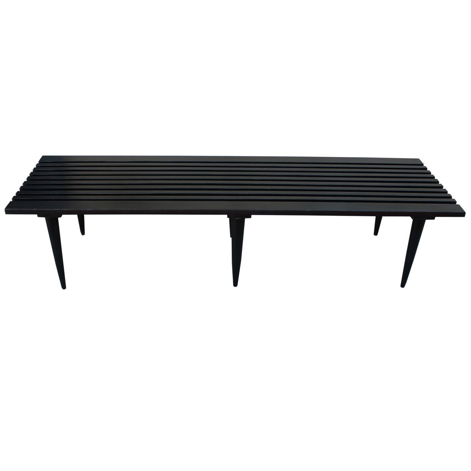 Sleek six legged bench or coffee table. Coffee table is finished in a satiny ebony stain. Table or bench will be perfect in a Mid-Century Modern, or transitional space.