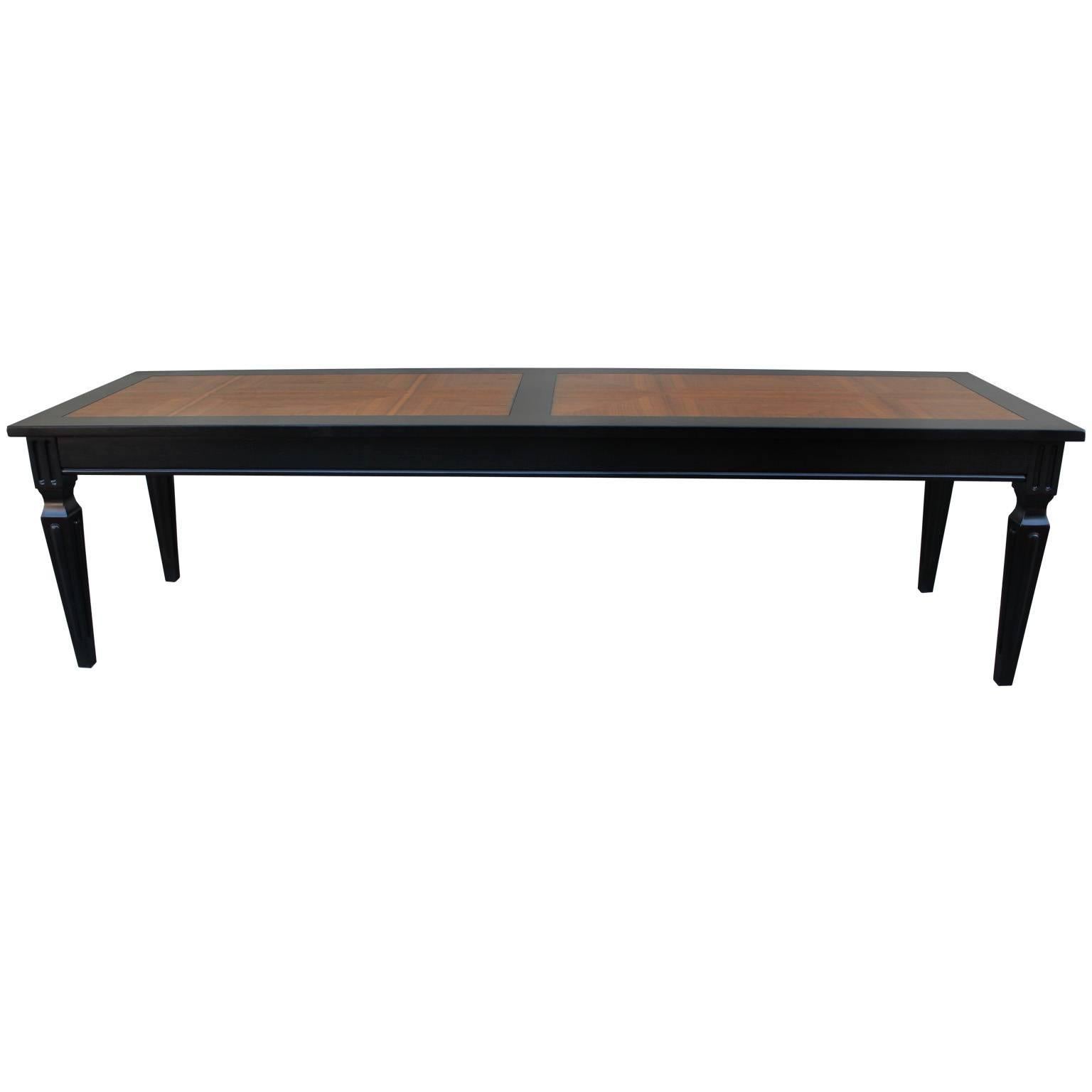 Elegant coffee table by Baker Furniture. Table base is freshly finished in a deep ebony stain. Tabletop is beautifully grained inlay or parquet. Legs have the perfect amount of detail. Excellent in a transitional, Mid-Century, or Hollywood Regency
