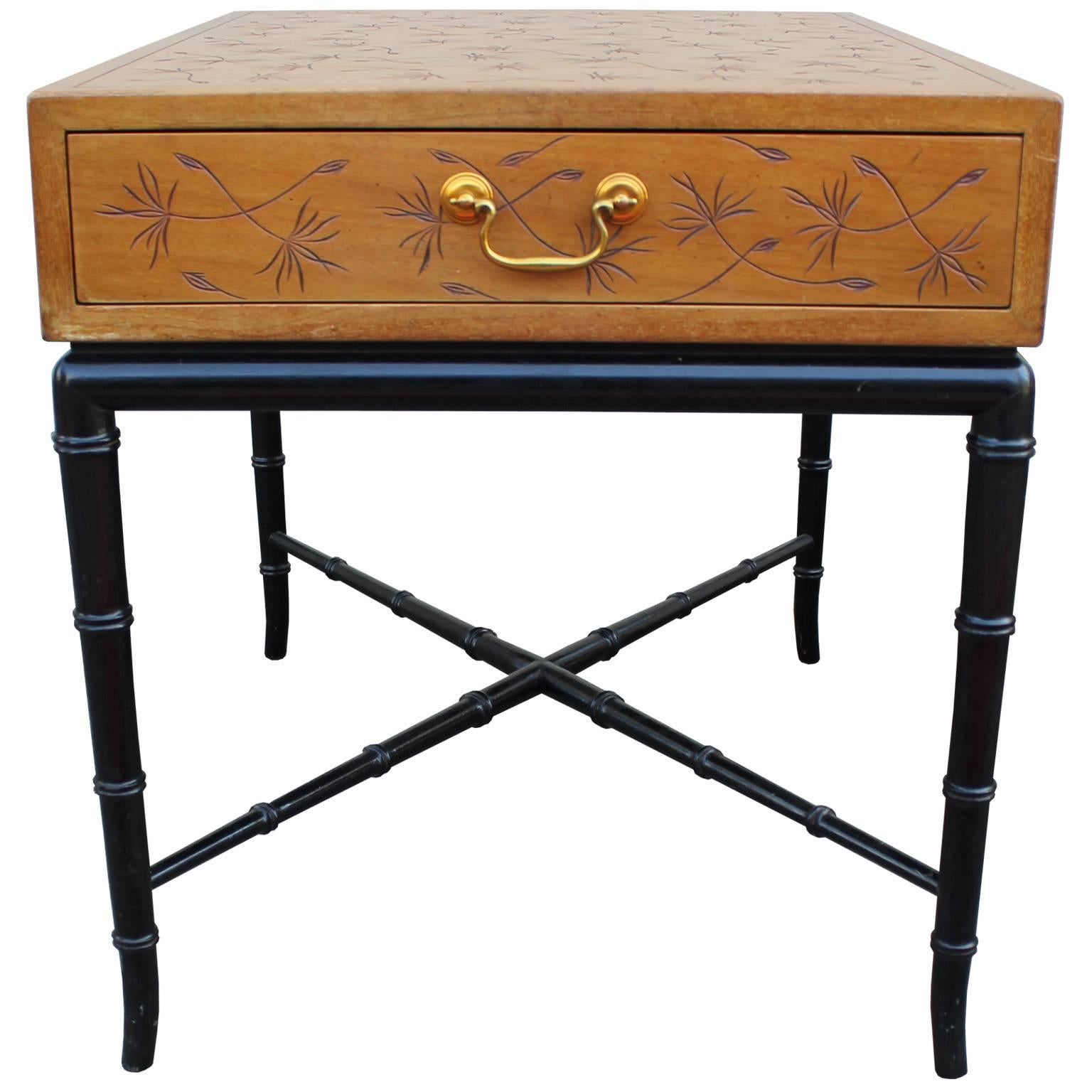 Beautiful pair of side tables or nightstands by Kittinger. Tables are incised with the iconic thistledown motif. Brass hardware accents the single drawer. Black lacquered faux bamboo base with X stretcher complete the table.