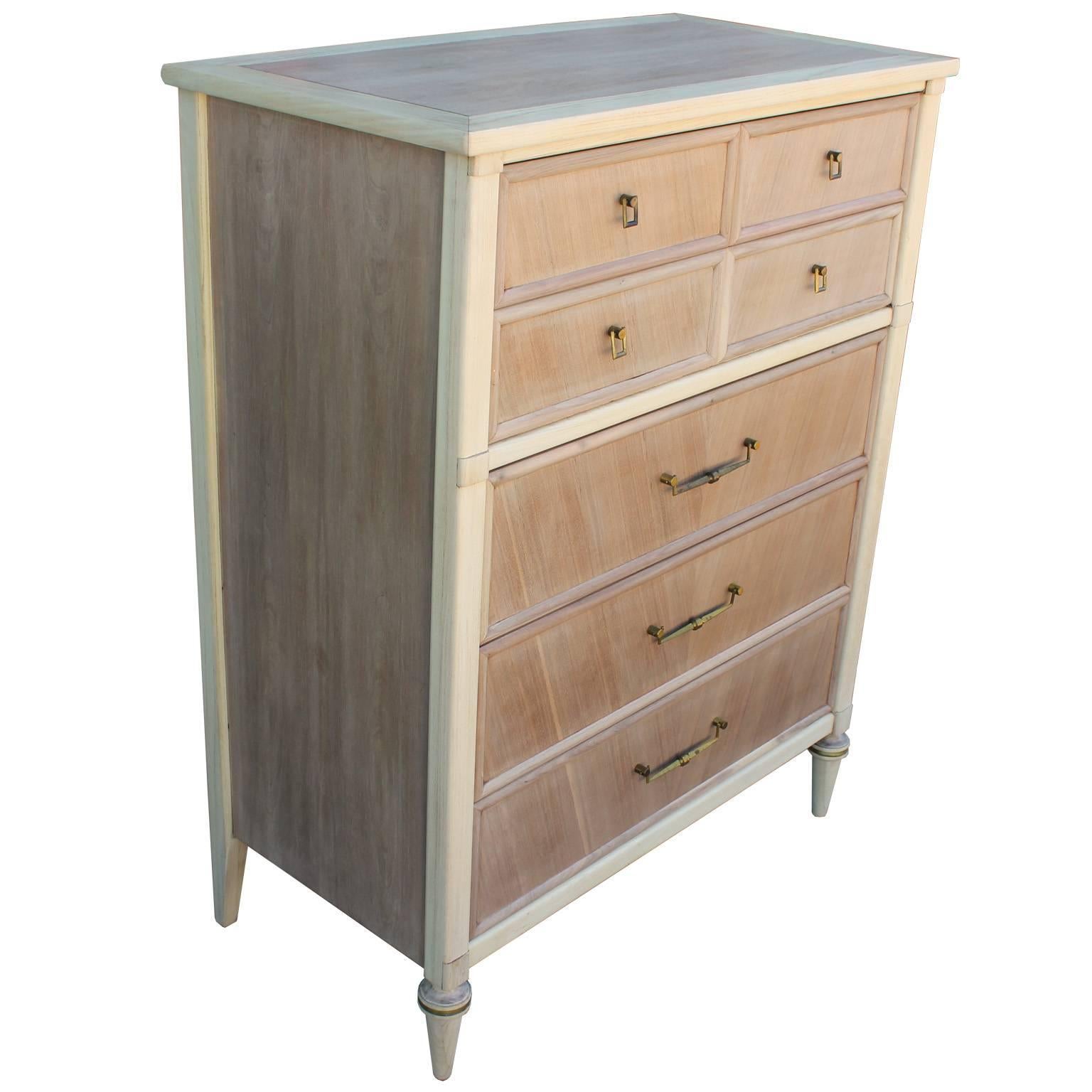 Glamorous two-tone, bleached dresser. Dresser has turned legs and beautiful details. Brass Accents complete the piece. Five drawers provide excellent storage. Stunning from all angles.