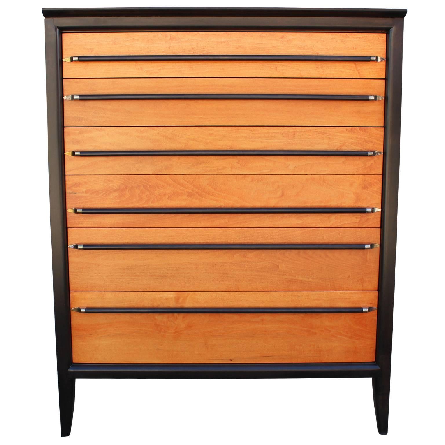 Beautiful six-drawer dresser. Case is finished in a deep ebony stain while drawer fronts are a natural golden color. Sleek wood handles are finished in ebony with patinaed chrome accents.