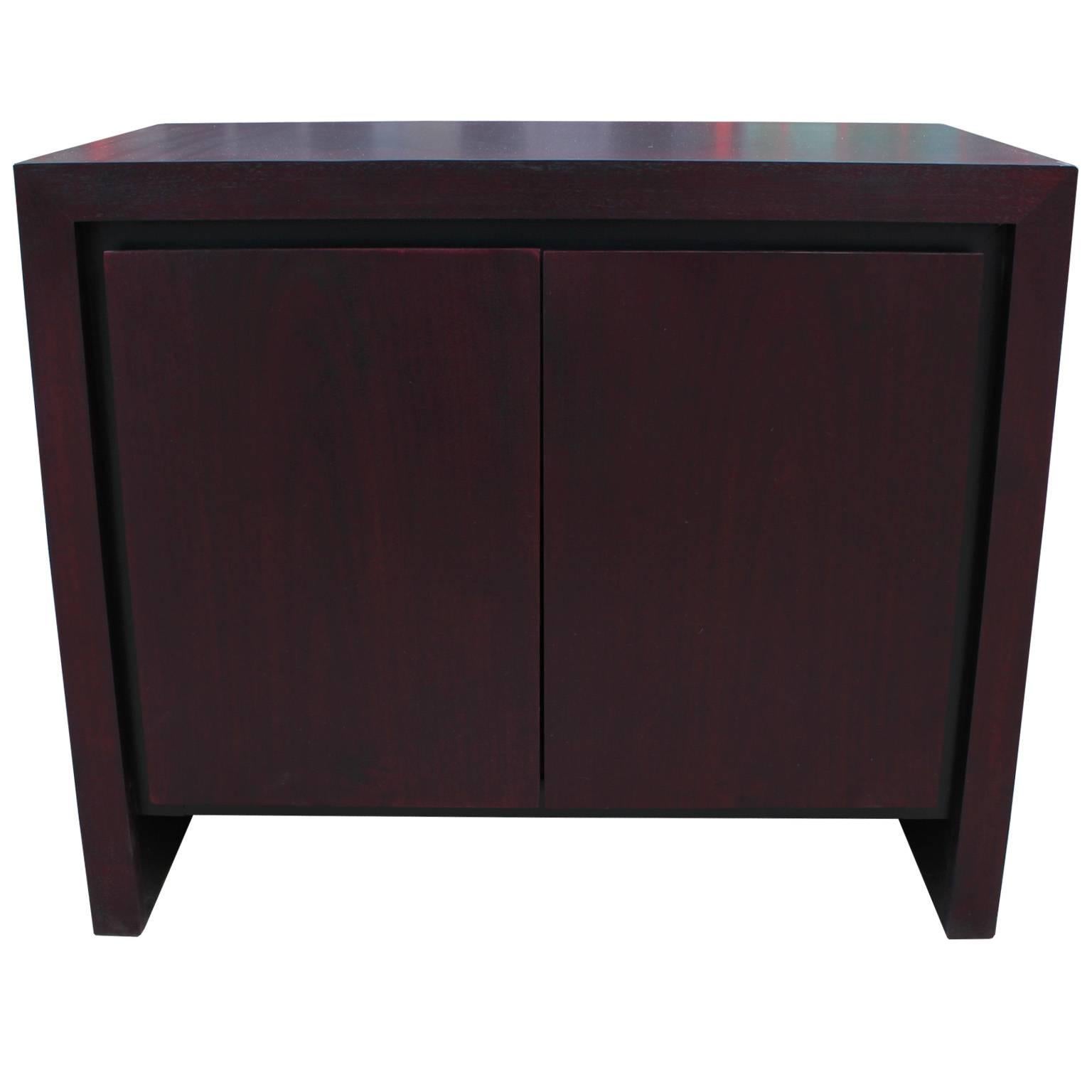 Wonderful pair of nightstands by Dillingham. Nightstands are finished in a bold purple stain. Doors open to reveal a single shelf. The more light in the room the more bold the finish becomes.