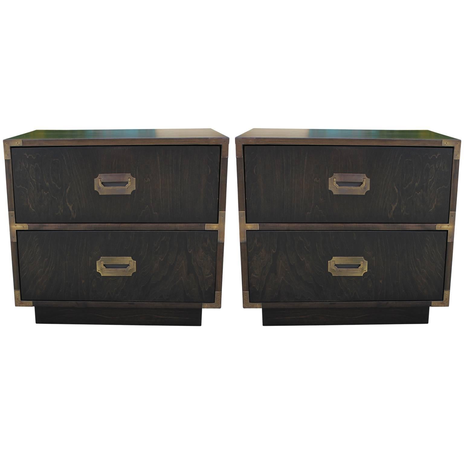 Excellent pair of Campaign style nightstands or end tables. Tables are finished in an ebony stain. Brass hardware has a wonderful patina. Newly restored. Made by Dixie.