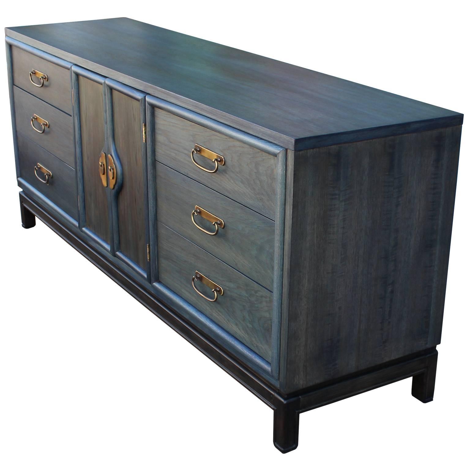 Wonderful dresser freshly refinished with a denim blue Aniline dye. Brass hardware. A black stained base completes the piece. Nine drawers provide excellent storage. Sideboard will add the perfect pop of color to any space.