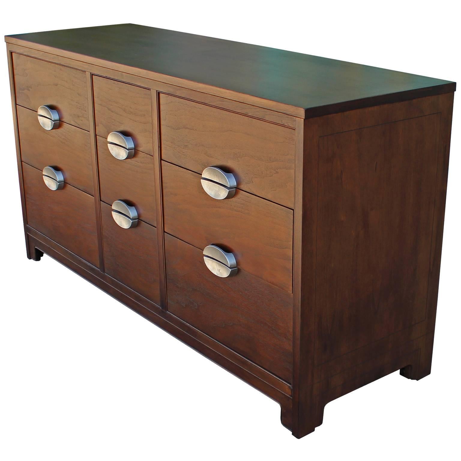 Clean lined nine-drawer dresser by Heritage Henredon. Dresser is freshly refinished in a dark walnut. Bold patinated nickel hardware.