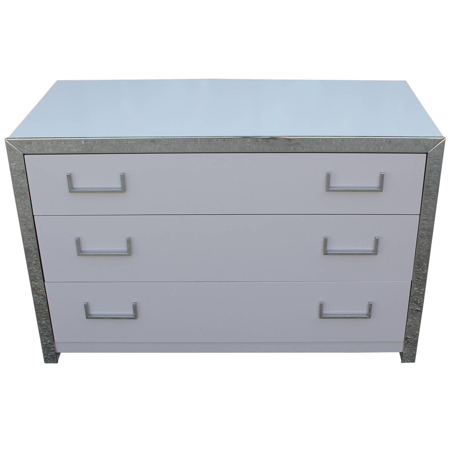 Clean lined, modern dresser or chest. Chest is finished in a light dove grey lacquer. Chrome hardware and accents.