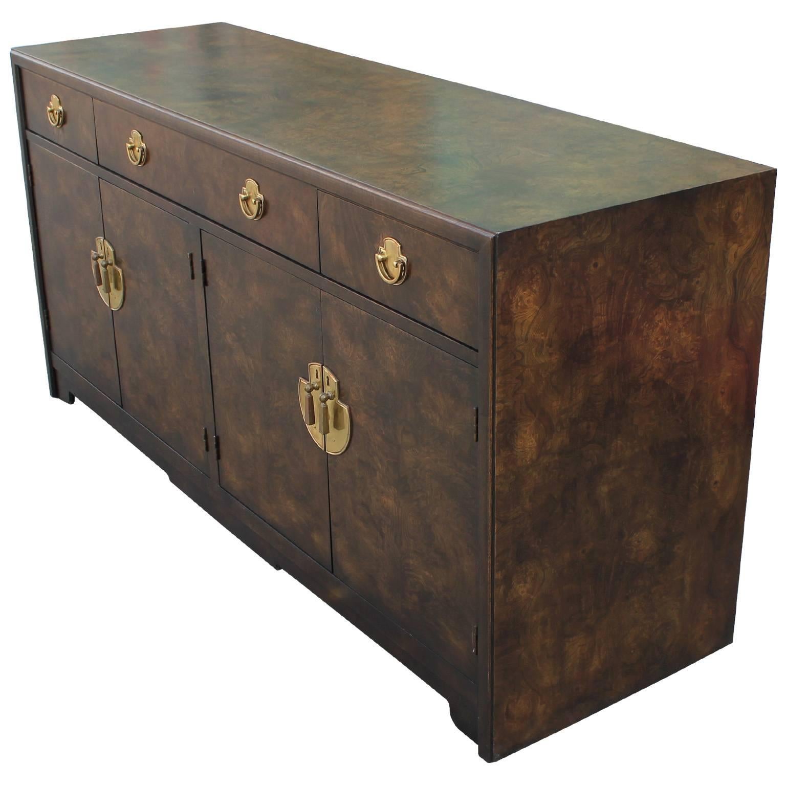 Glamorous burl wood dresser or sideboard. Nicely detailed brass hardware finish the piece. Cabinet drawers open to reveal drawers. Perfect in a Hollywood Regency, transitional, or Mid-Century space. In excellent condition.
