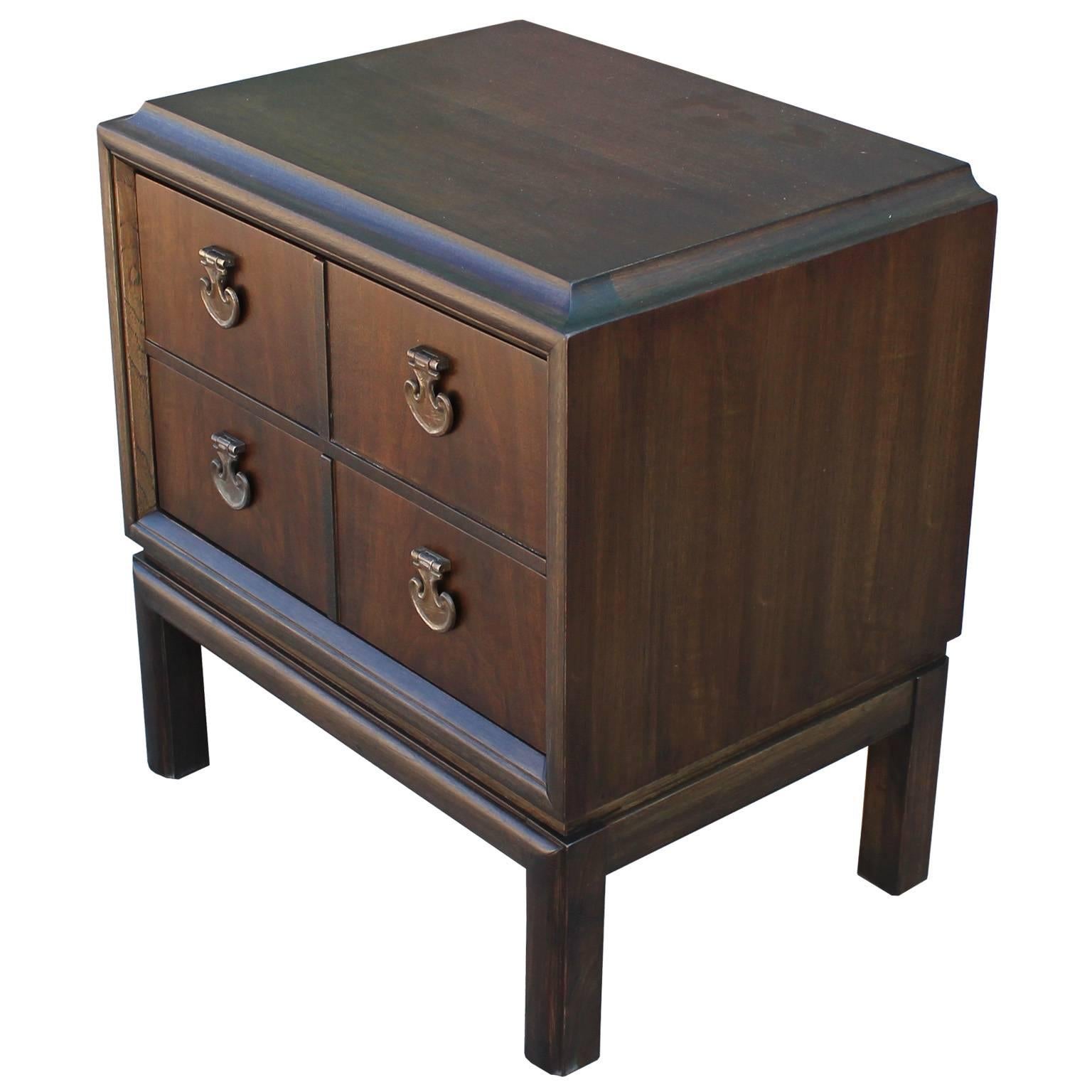 Luxe single nightstand or bedside table. Tables are finished in a dark walnut stain. Brass hardware has an excellent patina. Two drawers provide storage. Perfect in a Hollywood Regency, transitional, or Mid-Century space.