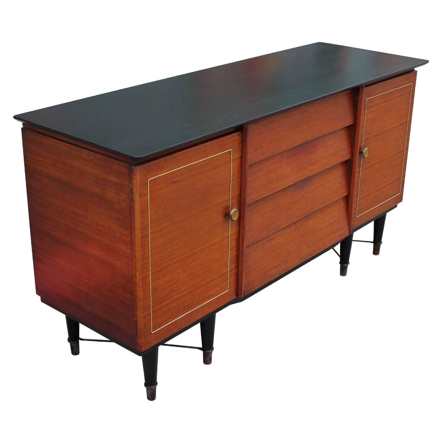 Elegant louvered sideboard, credenza or cabinet. Freshly finished in a medium teak with ebony accents. Brass accents complete the piece along with a stretched brass X-base. Two cabinets and four drawers provide storage. Stunning from all angles.