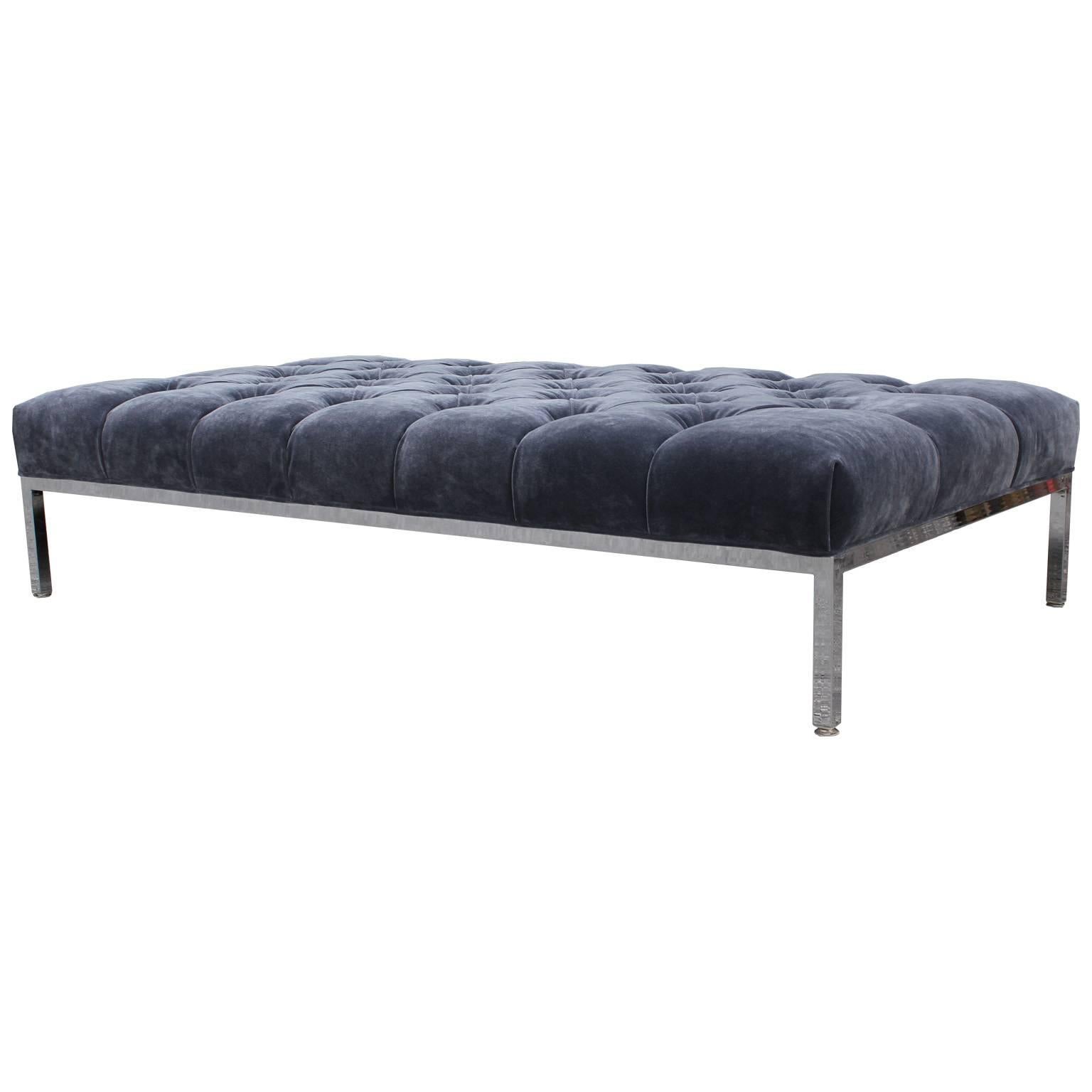 Fabulous ottoman, bench or coffee table freshly upholstered in a deeply tufted grey velvet. A clean lined Zographos style chrome base. Perfect used a coffee table. In excellent restored condition.