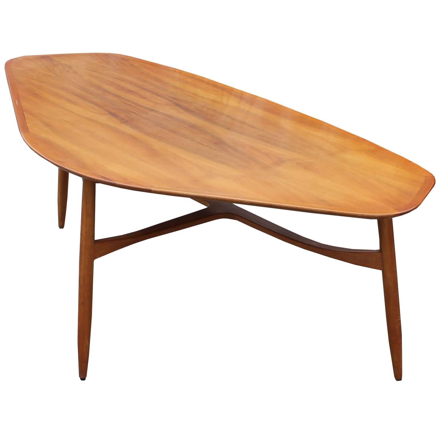 Wonderful blonde wood asymmetrical tri-leg sculptural table. This wonderful table is excellently constructed and has bold presence. The table is signed on the bottom however it is not legible. It is in great vintage condition and slightly taller