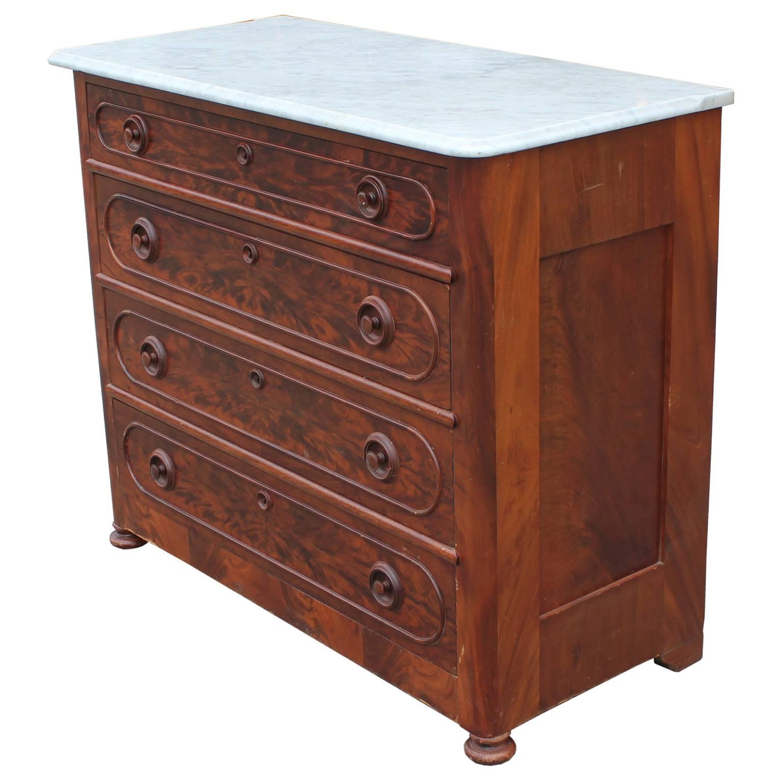 Matched grain bold four drawers locking chest with Carrara marble top. The Victorian era chest has a modern grand look to it and would function across design eras. The piece is in nice vintage condition and can be restored for an additional cost. We